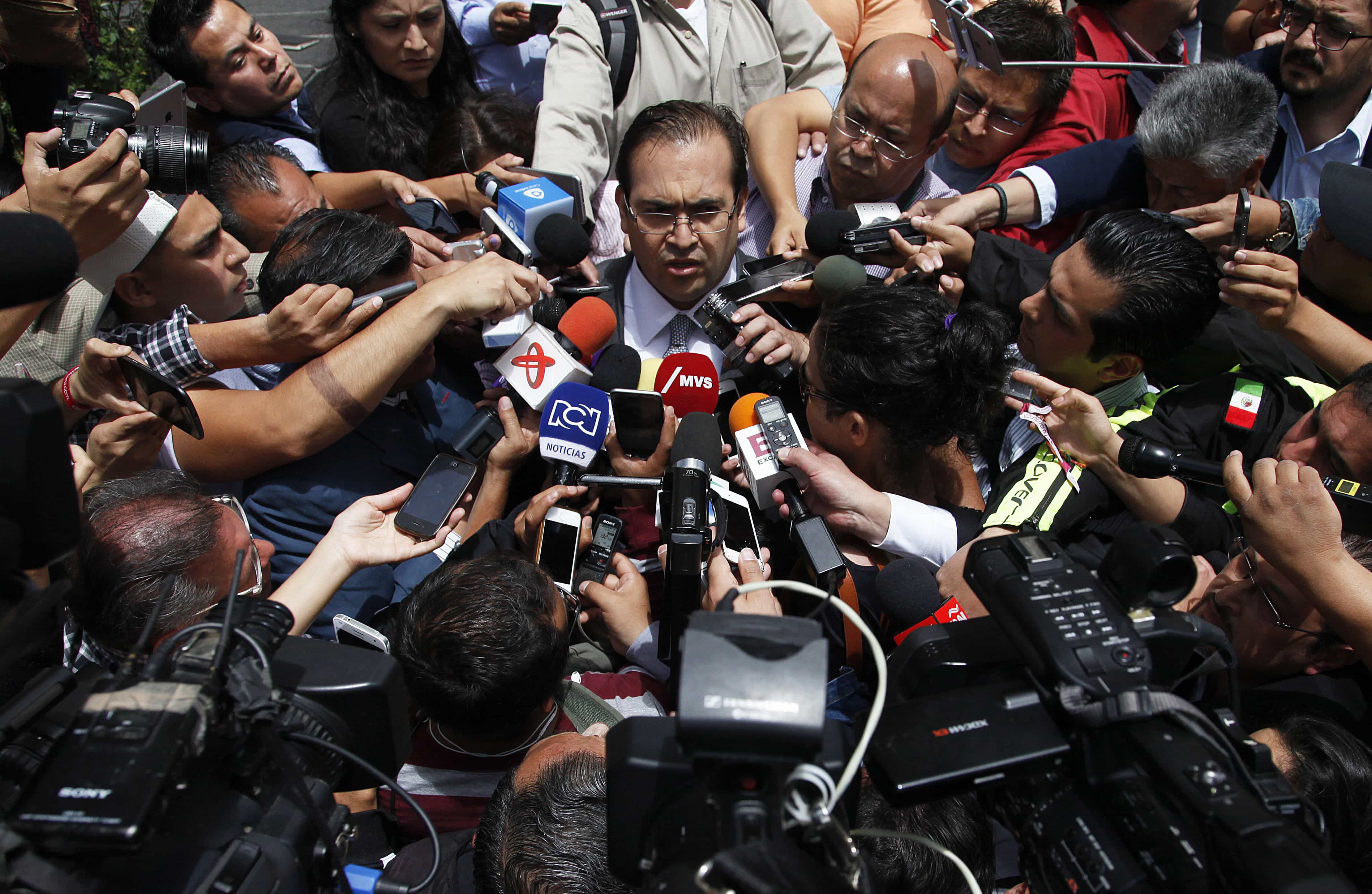 The press swarms around outgoing Veracruz Gov. Javier Duarte as he leaves the Attorney General's headquarters in Mexico City, AP Photo/Marco Ugarte