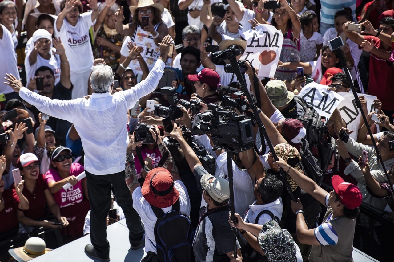 Members of the press stand behind Mexico's presidential candidate for the MORENA party, Andres Manuel Lopez Obrador, during a campaign rally in Acapulco, Guerrero State, Mexico, 25 June 2018, PEDRO PARDO/AFP/Getty Images