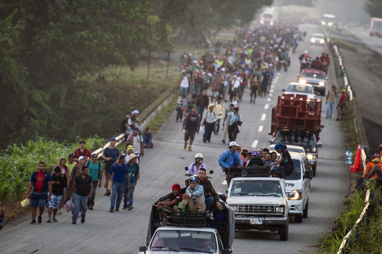 Honduran migrants walking and aboard trucks head in a caravan to the US, in Huixtla, Mexico, 24 October 2018, PEDRO PARDO/AFP/Getty Images