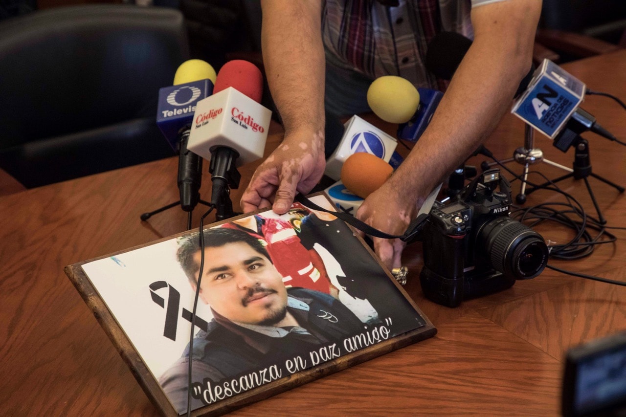 A member of the media displays an image of slain Mexican journalist Edgar Daniel Esqueda Castro, in protest, before the start of a press conference called by the state governor at the State House in San Luis Potosi, Mexico, 6 October 2017, AP Photo/Christian Palma