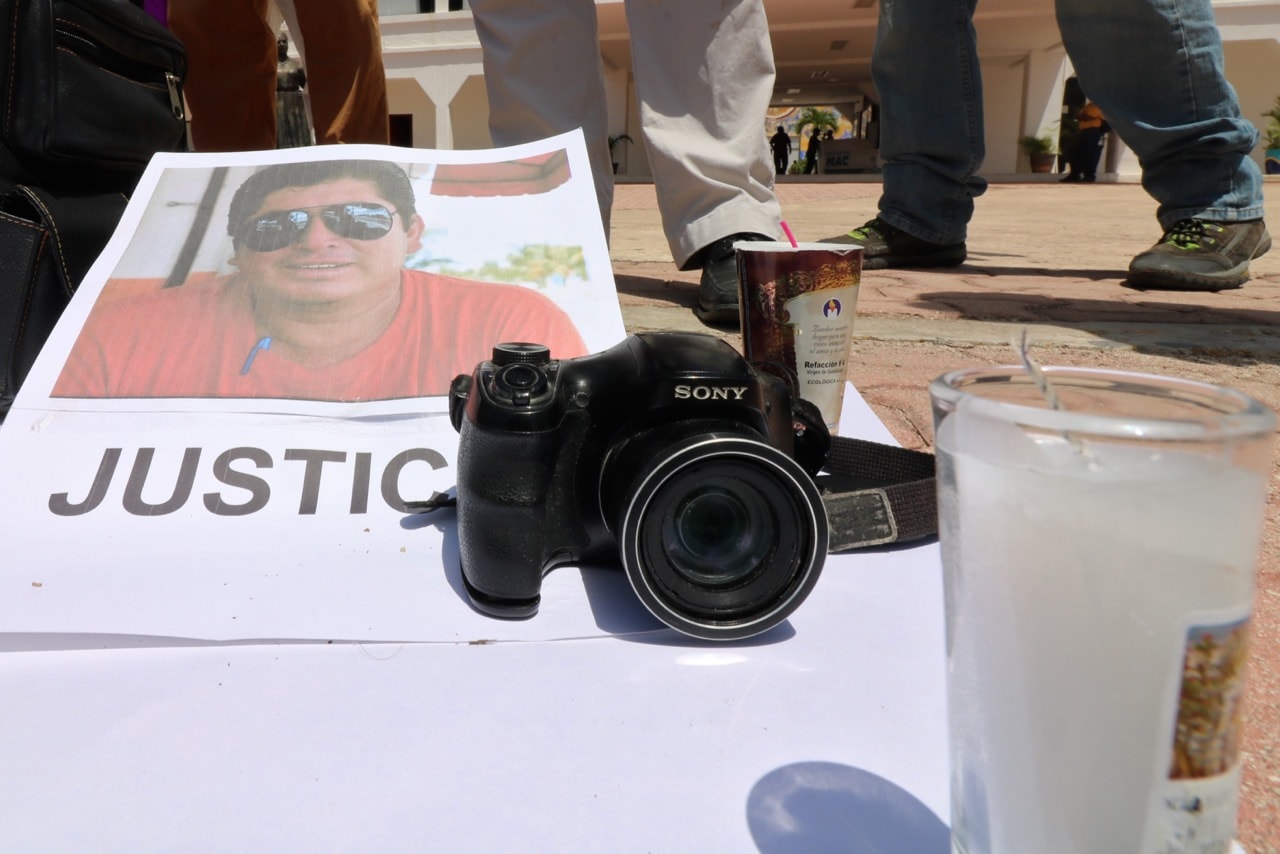 The portrait of Mexican journalist José Guadalupe Chan Dzib is seen as his colleagues protest outside the City Hall in Playa del Carmen, Quintana Roo state, Mexico, 30 June 2018, JOEL TZAB/AFP/Getty Images