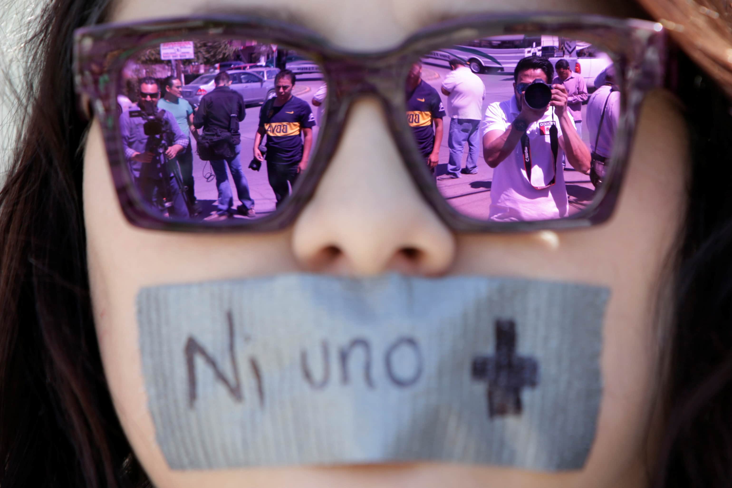 Journalists are reflected on the sunglasses of a woman during a protest against the murder of journalist Miroslava Breach, in Ciudad Juarez, Mexico, 25 March 2017. The tape reads "Not one more" , REUTERS/Jose Luis Gonzalez