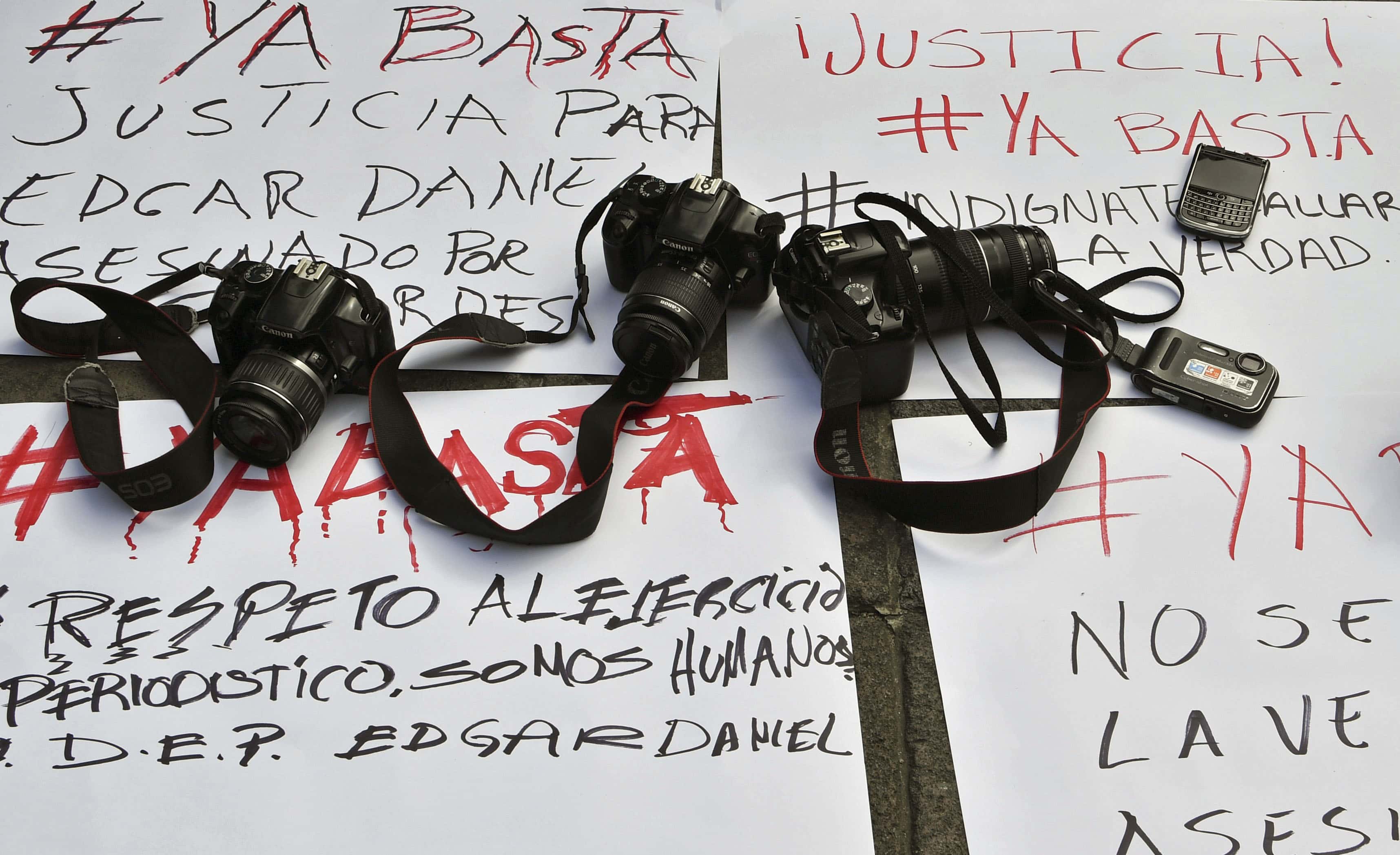 Cameras and messages of protest during a demonstration by photojournalists to demand justice for slain Mexican colleague Edgar Daniel Castro in San Luis Potosi, Mexico on October 6, 2017, YURI CORTEZ/AFP/Getty Images