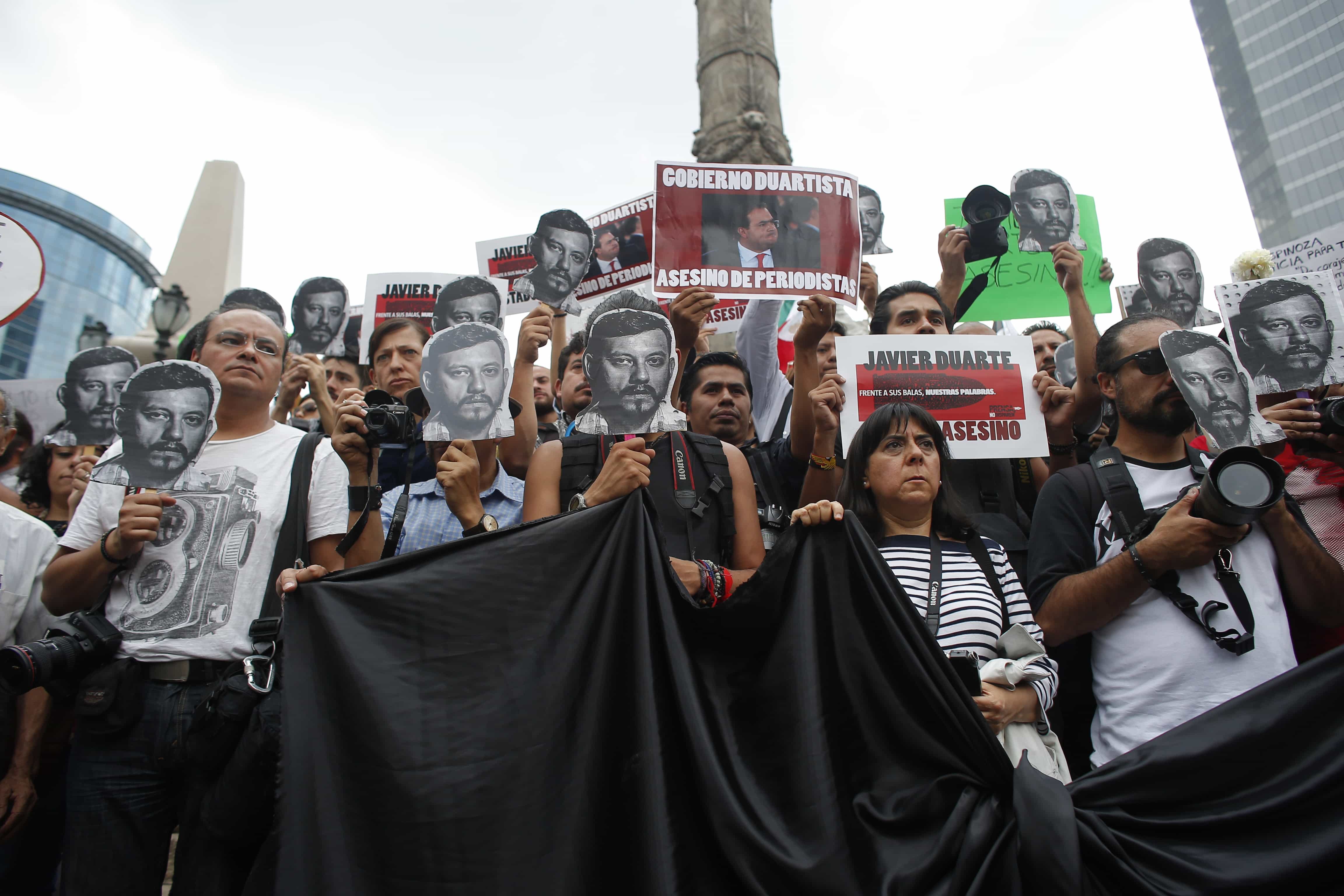Journalists and activists hold up cut-out images of slain photojournalist during a protest in Mexico City, 2 August 2015, AP Photo/Dario Lopez-Mills