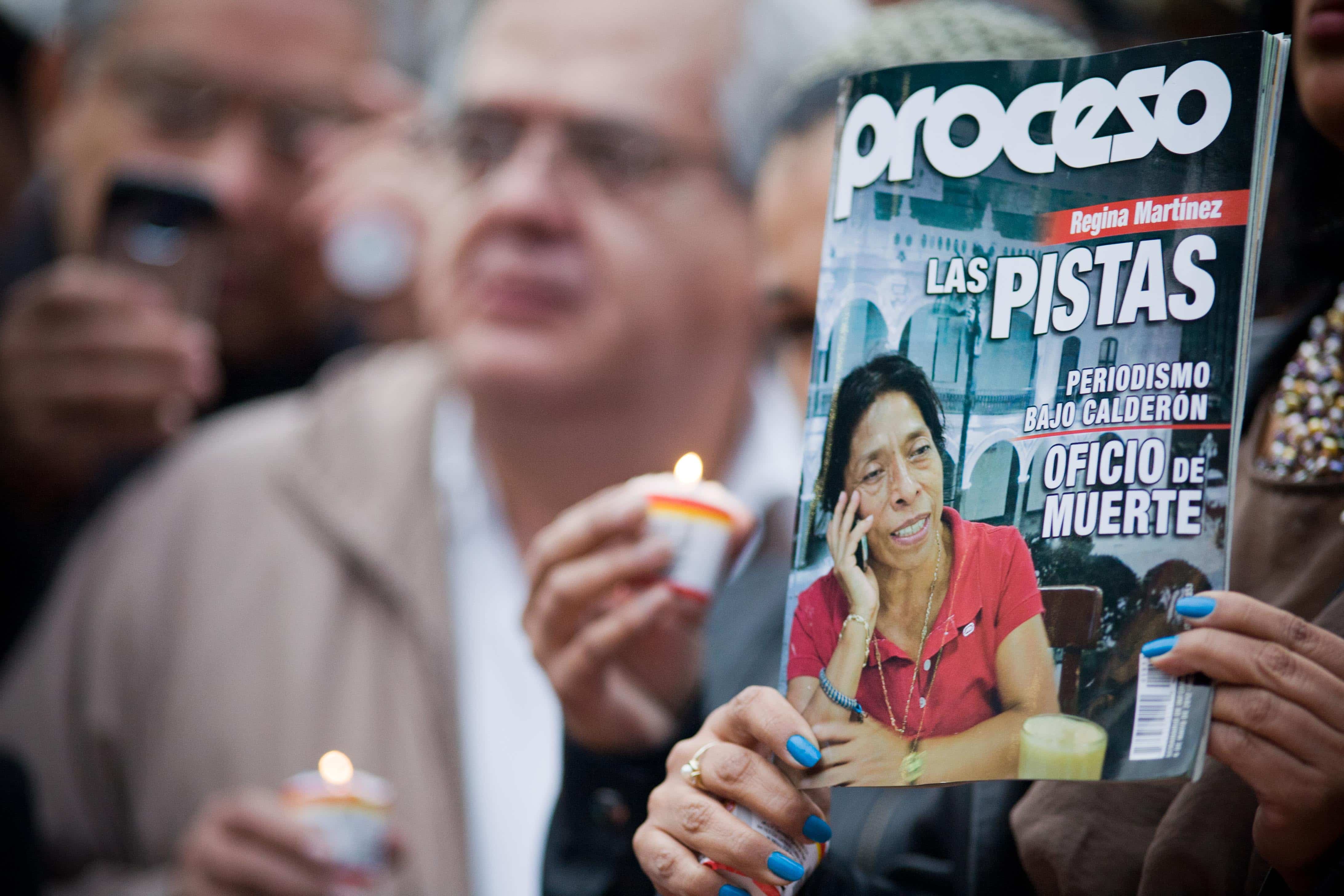 A journalist in Mexico City holds up an issue of Proceso magazine, dedicated to murdered journalist Regina Martínez, May 2012., Ivan_Duff Cuevas Hernandez/Demotix