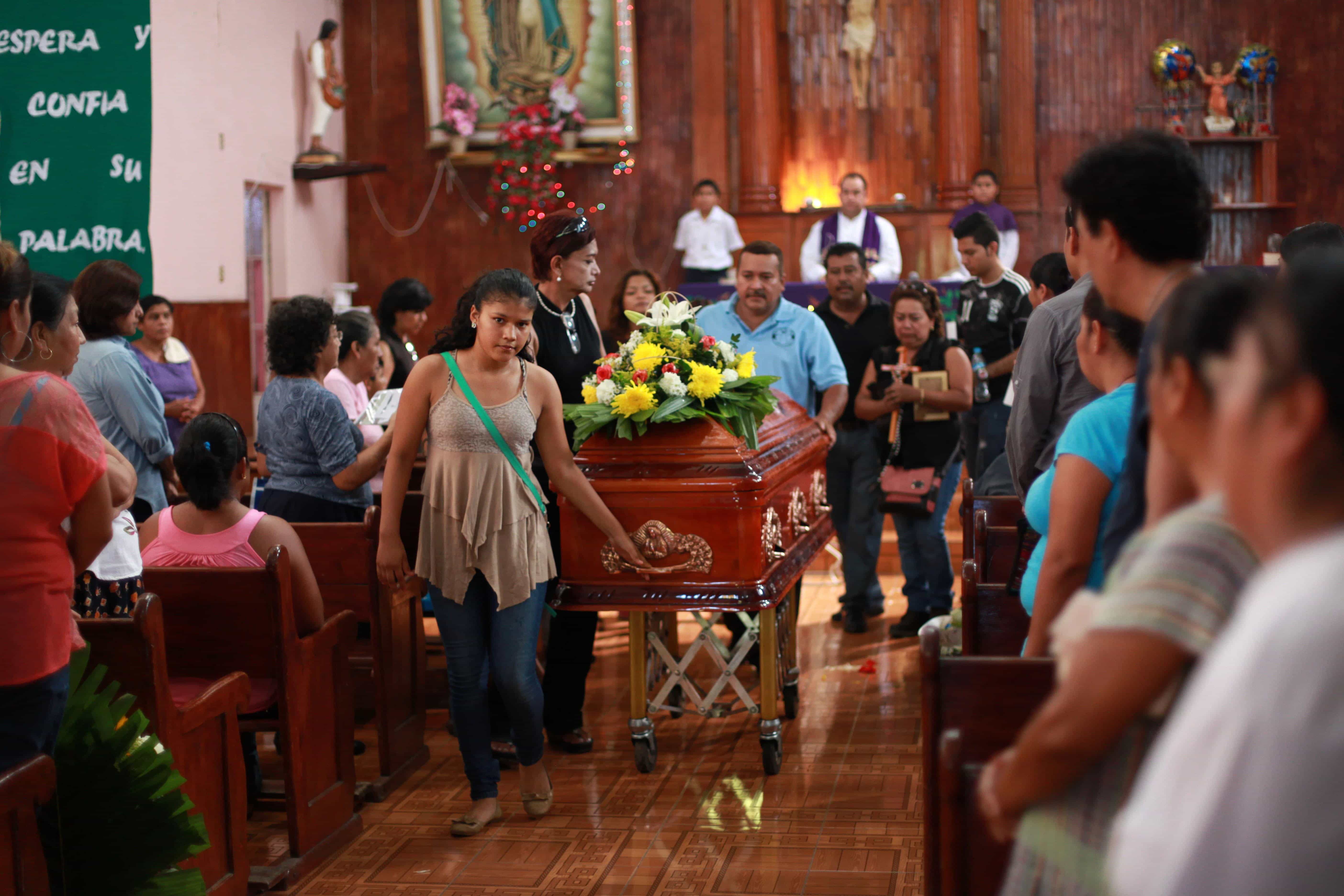 Friends and relatives of journalist Octavio Rojas attend his funeral in Tezonapa, Mexico on 12 August 2014, AP Photo/Felix Marquez