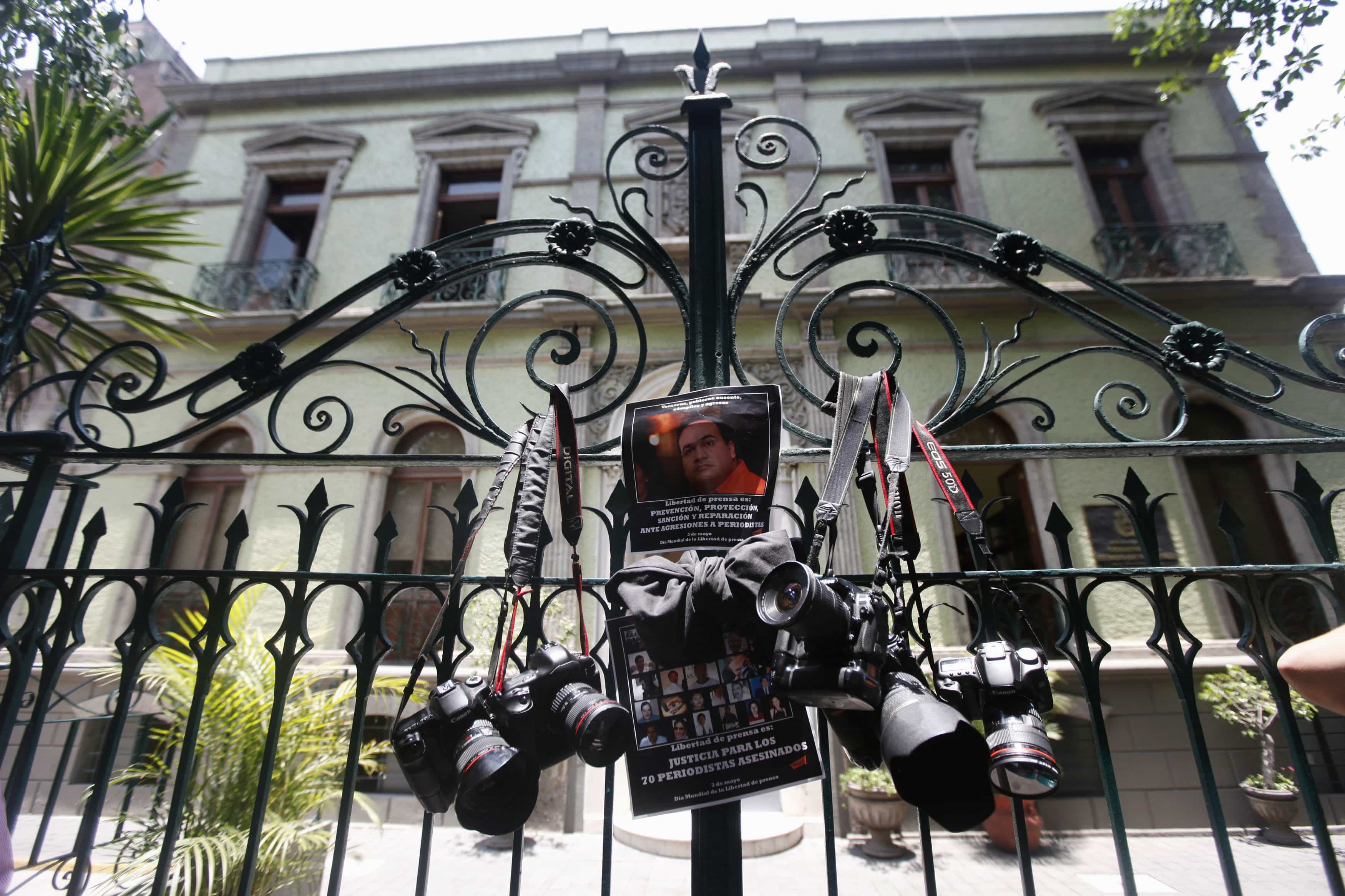 Journalists hang their cameras on the gates of a Veracruz government building to protest the repeated killings of journalists in the state, REUTERS/Edgard Garrido