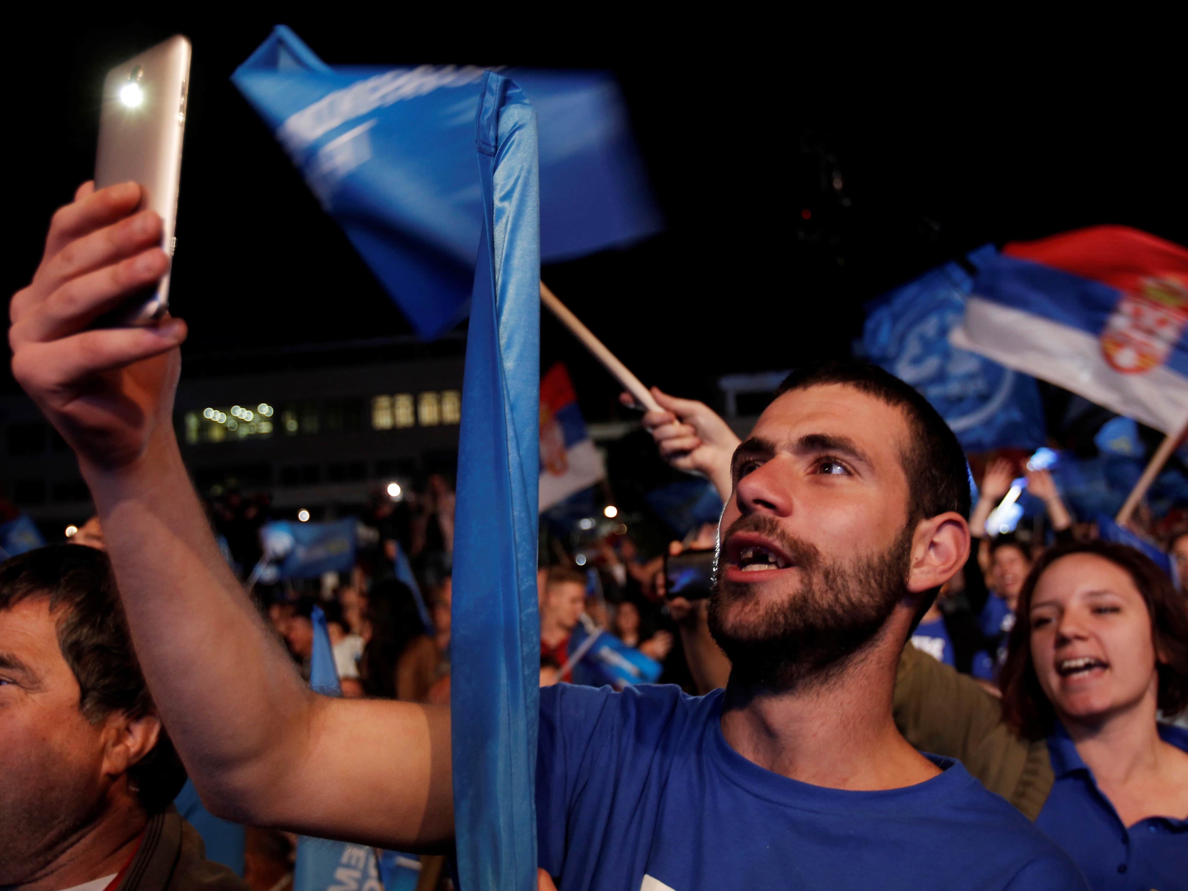 A supporter of opposition Democratic Front alliance takes a selfie during a pre-election rally in Podgorica, Montenegro, 14 October 2016, REUTERS/Stevo Vasiljevic