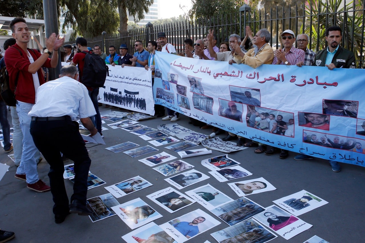 Protesters supporting the ongoing anti-government protest hold a banner outside the Court of Appeal of Casablanca, Morocco, on 3 October 2017, where the trial of the activists who were implicated in the events of the northern town of Al Hoceima is taking place, AP Photo/Abdeljalil Bounhar