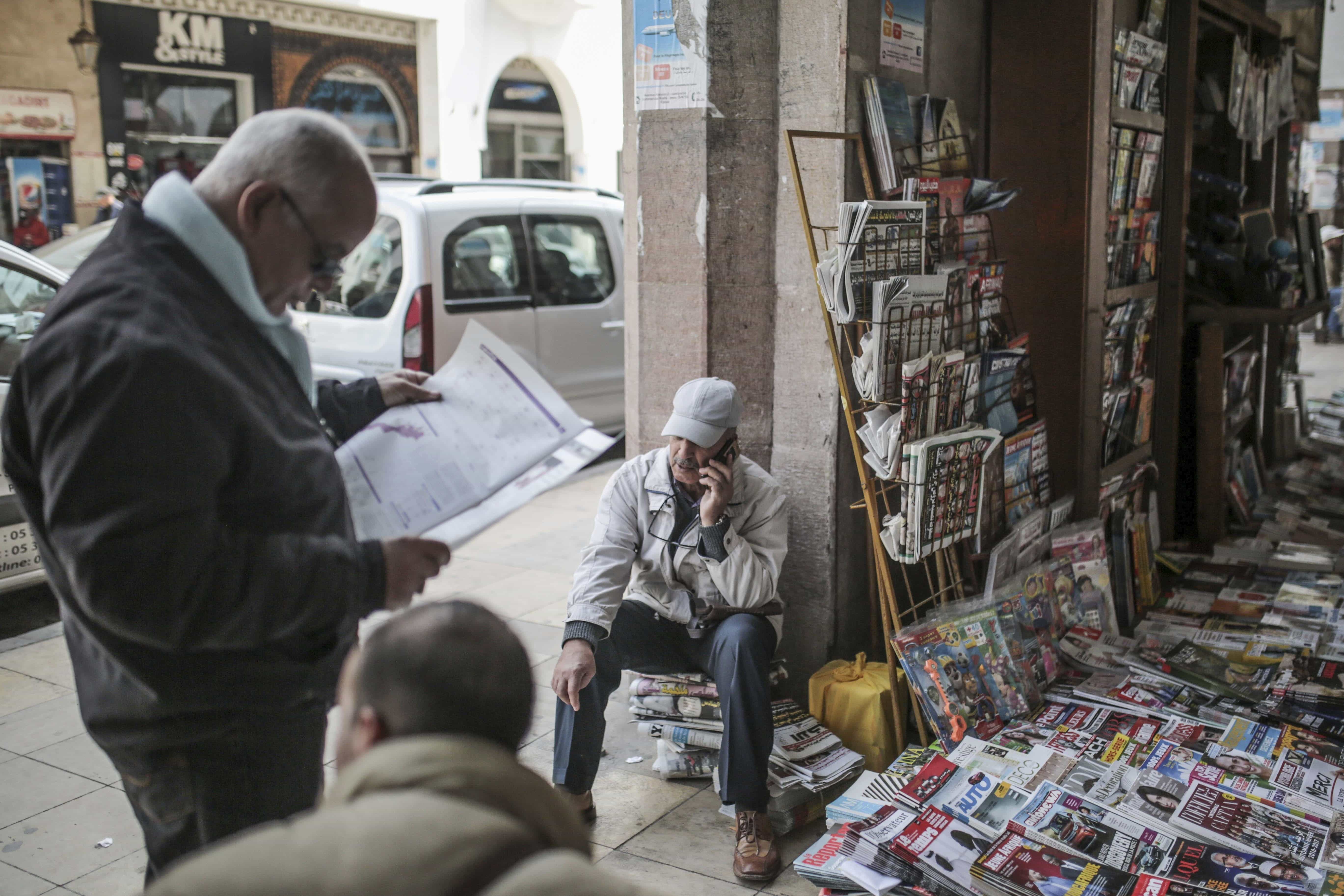 A man reads a newspaper at a stall near the Medina of Rabat, Morocco, 16 March 2017, AP Photo/Mosa'ab Elshamy