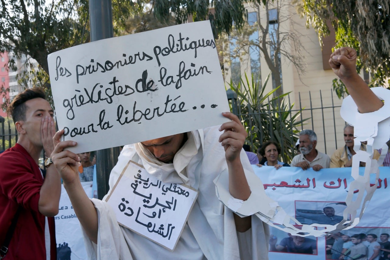 Protesters supporting the ongoing anti-government protest hold banners that read: "Political Prisoners Hunger Strikers for Freedom", top, and "The Prisoners of the Rif Freedom or Death", outside the Court of Appeal of Casablanca, Morocco, on 3 October 2017, AP Photo/Abdeljalil Bounhar