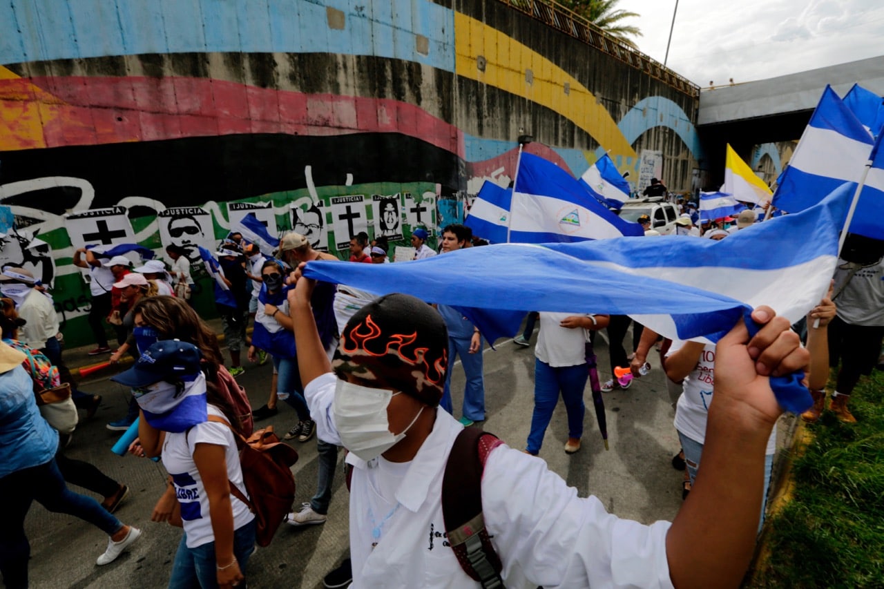 University students and medical doctors dismissed from public hospitals for treating wounded anti-government protesters, march against Nicaraguan President Daniel Ortega and his wife, Vice-President Rosario Murillo, in Managua, 31 July 2018, INTI OCON/AFP/Getty Images