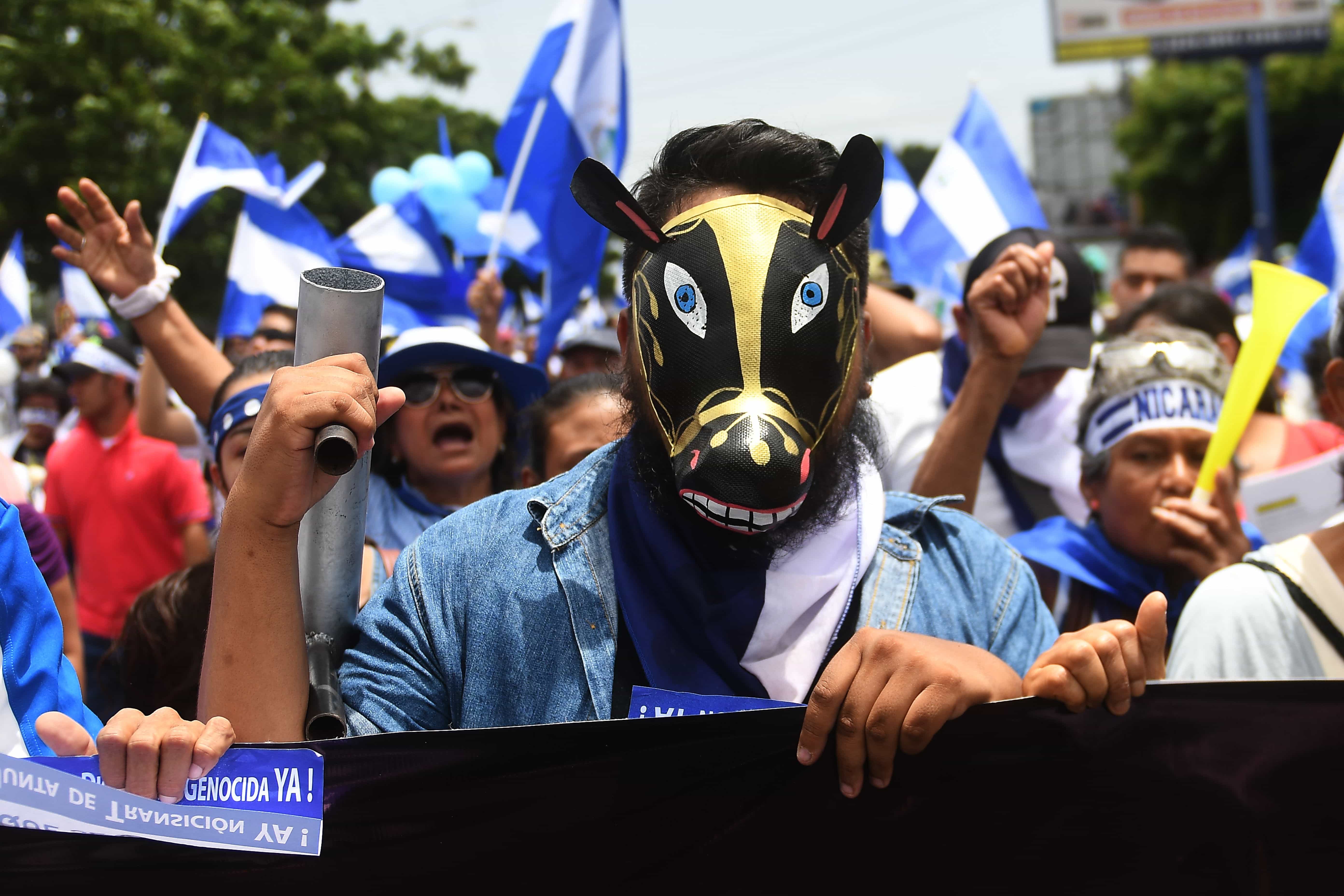 People attend the 'Marcha de las Flores' -in honor of the children killed during protests- in Managua, Nicaragua, 30 June 2018, MARVIN RECINOS/AFP/Getty Images