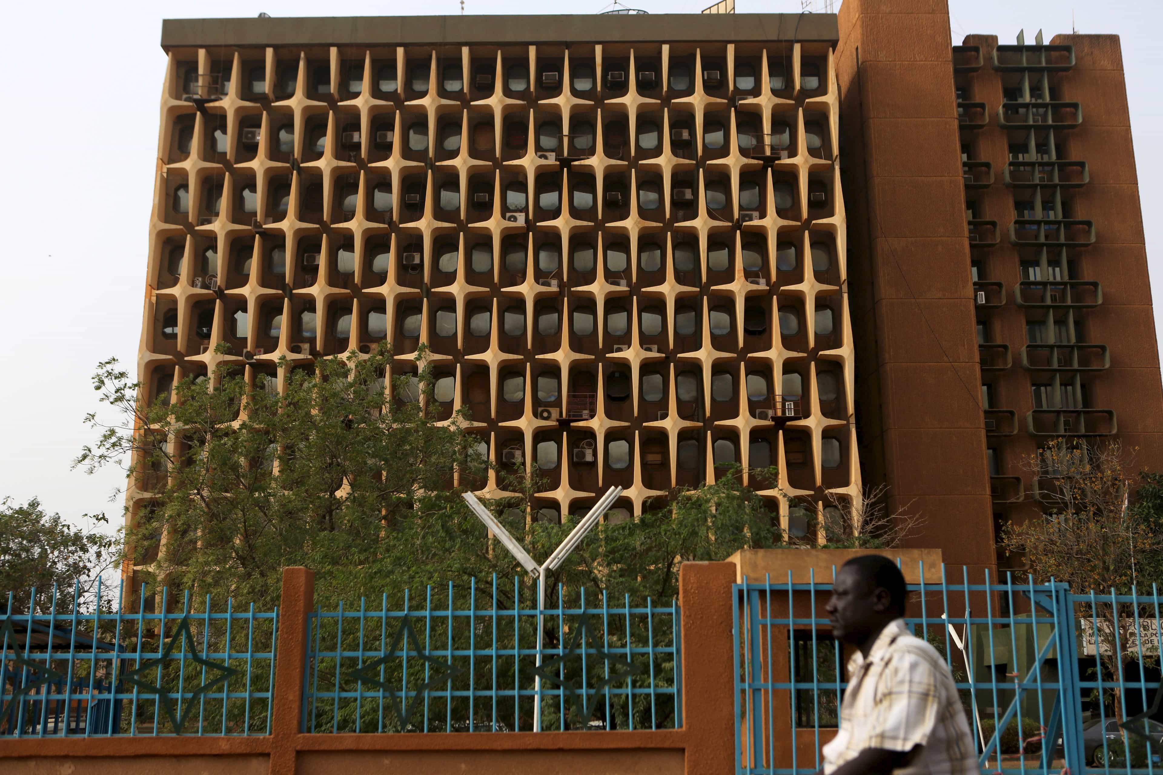 A man rides a motorcycle past a government building in Niamey, Niger, 20 February 2016, REUTERS/Joe Penney