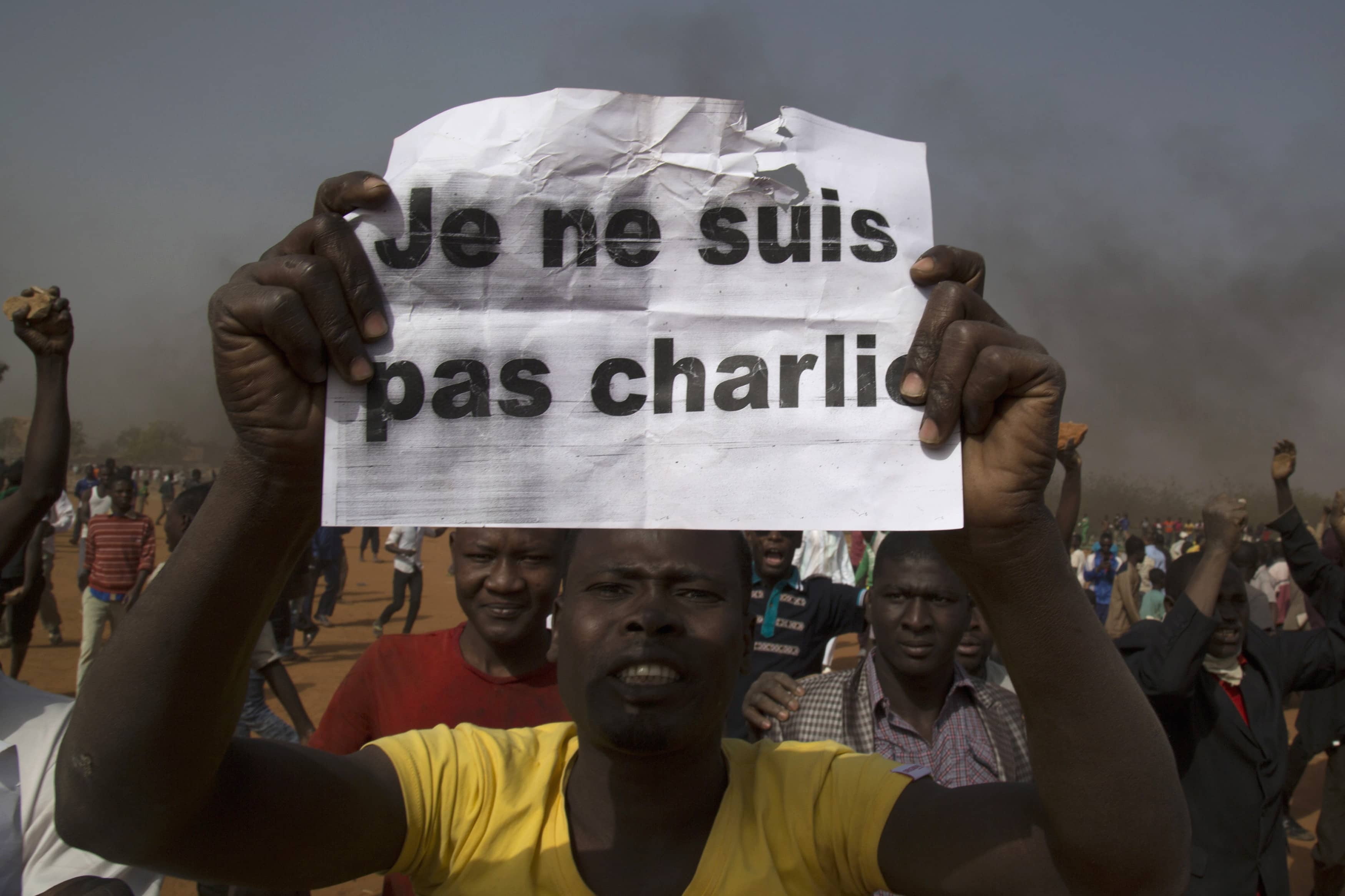 A man holds a sign during a protest against Niger President Mahamadou Issoufou's attendance at a Paris rally in support of Charlie Hebdo, Niamey, 17 January 2015, REUTERS/Tagaza Djibo