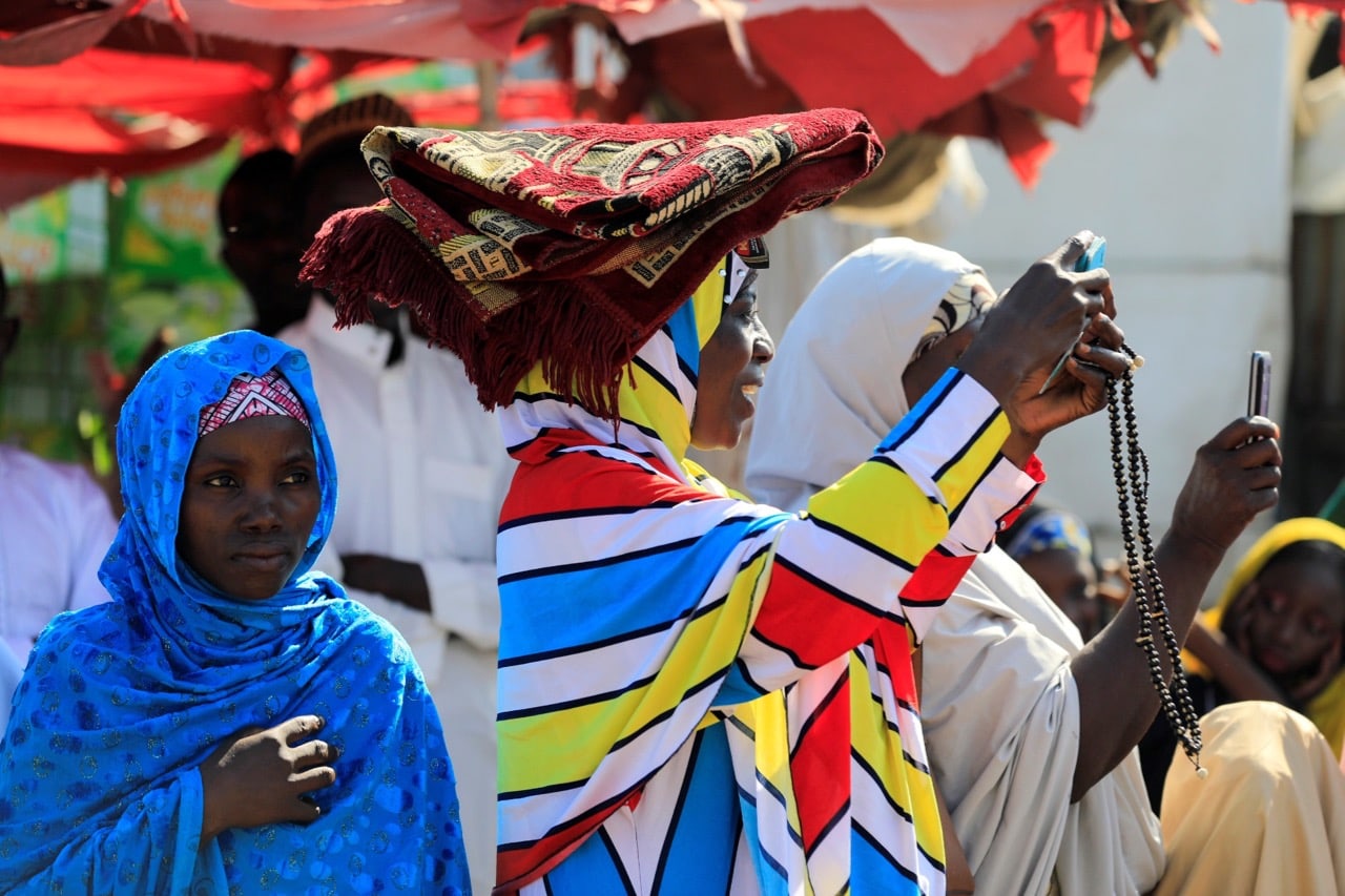 A woman uses a mobile phone to make photographs in Nigeria's northern city of Kano, 1 September 2017, REUTERS/Akintunde Akinleye