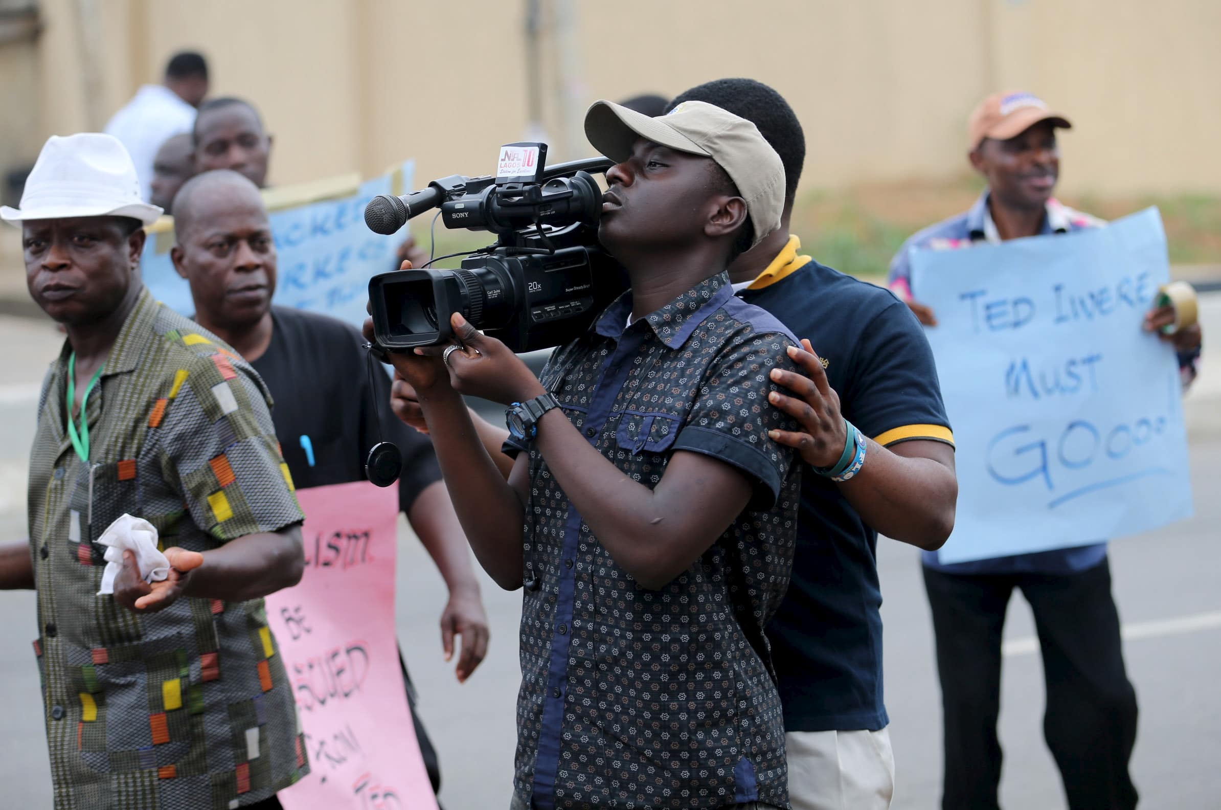 A cameraman films a protest in Lagos, Nigeria, 28 October 2015, REUTERS/Akintunde Akinleye