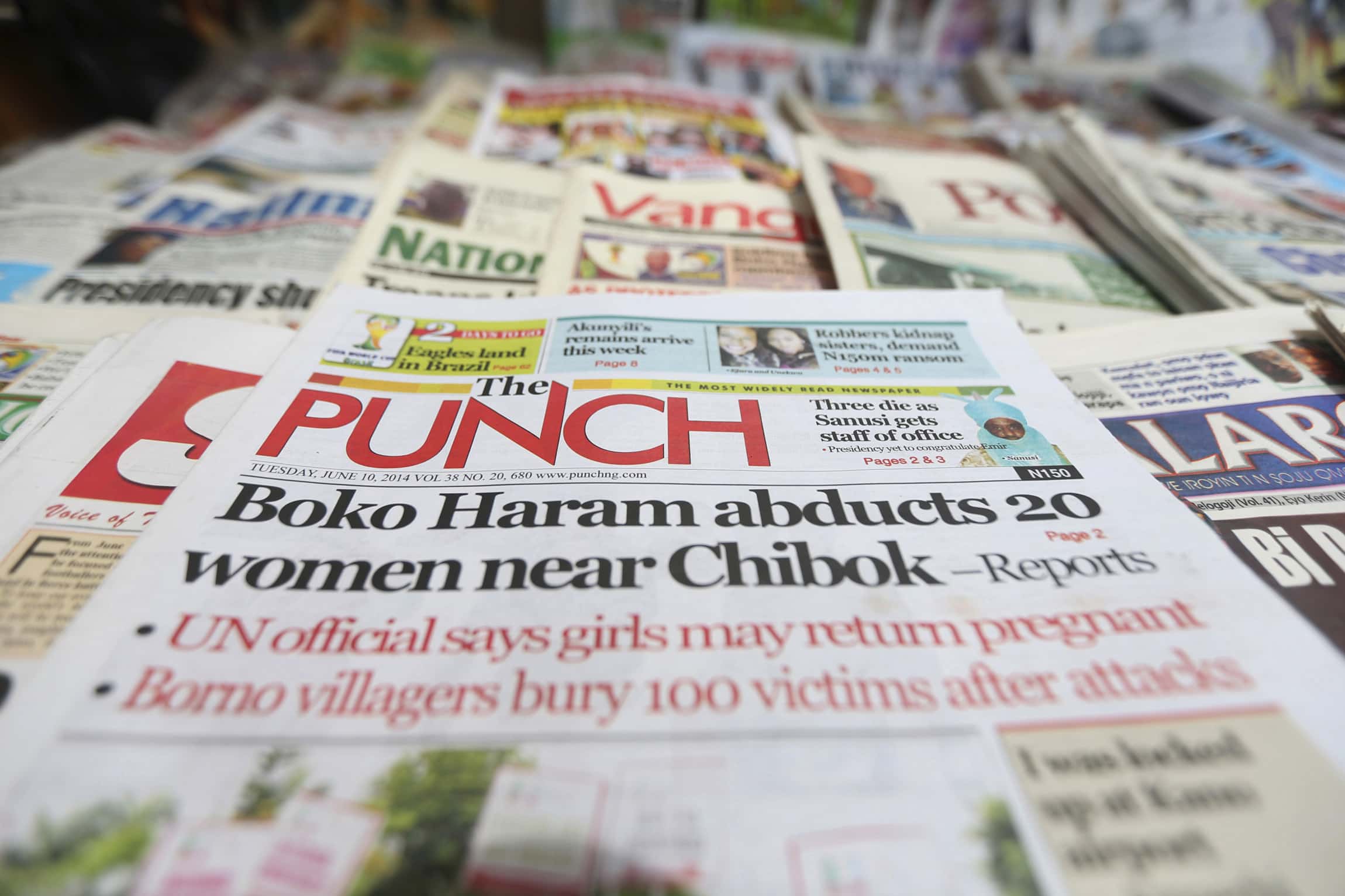 A newspaper with its frontpage headline on an abduction of women from a village in northeast Nigeria, is displayed at a vendor's stand in Lagos, 10 June 2014, REUTERS/Akintunde Akinleye