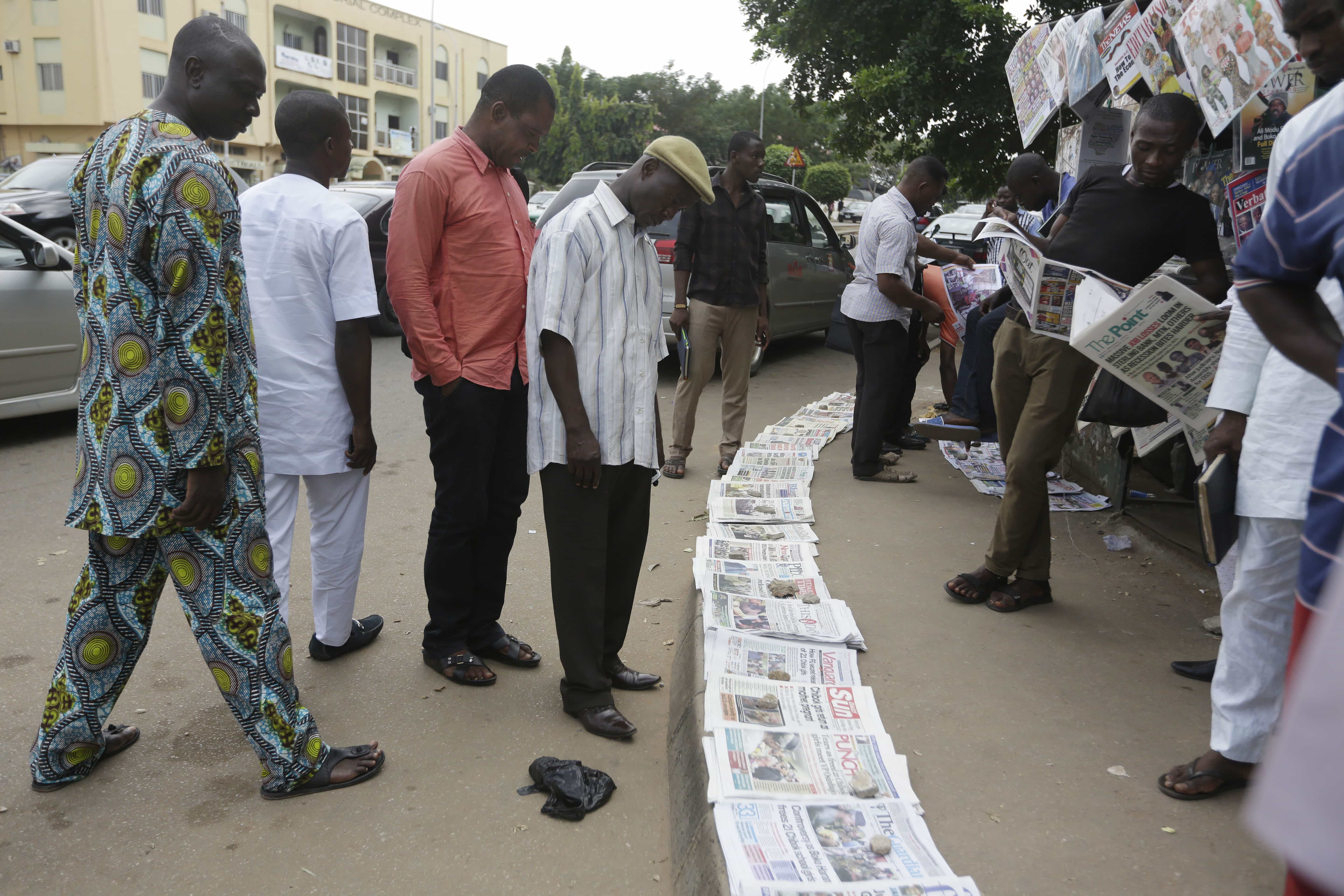 People read newspapers, in Abuja, Nigeria, 14 October 2016, AP Photo/Sunday Alamba