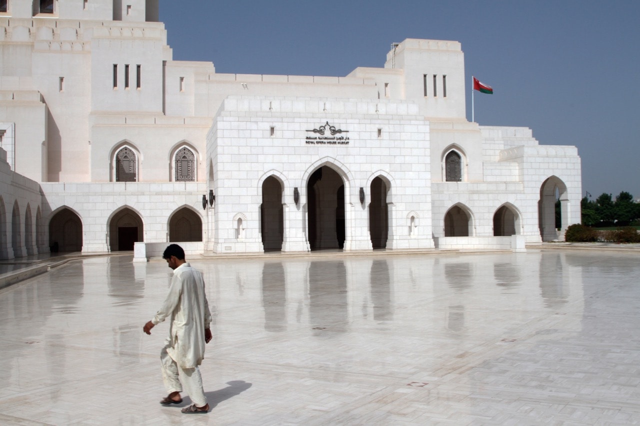 A man walks in front of the Royal Opera House Muscat in the Shati Al-Qurm district of the Omani capital Muscat, 19 July 2016, Dominic Dudley/Pacific Press/LightRocket via Getty Images