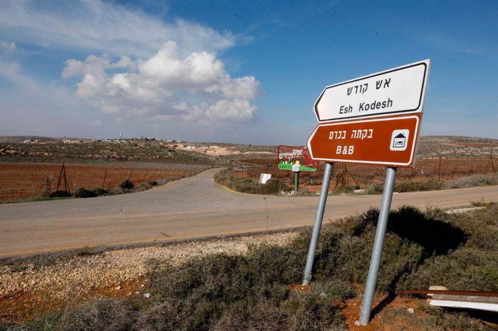 A road sign points towards an Airbnb apartment, near the Jewish settlement of Shilo and the Palestinian village of Qusra in the occupied West Bank, 20 November 2018; Booking.com was urged to follow the example of Airbnb and withdraw listings for rentals located in settlements in the Israeli-occupied West Bank, MENAHEM KAHANA/AFP/Getty Images