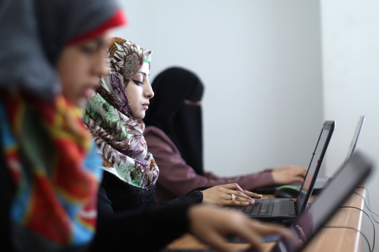 Palestinian women work on their laptops at the Unit One start up in Gaza City, 18 April 2015, MAHMUD HAMS/AFP/Getty Images