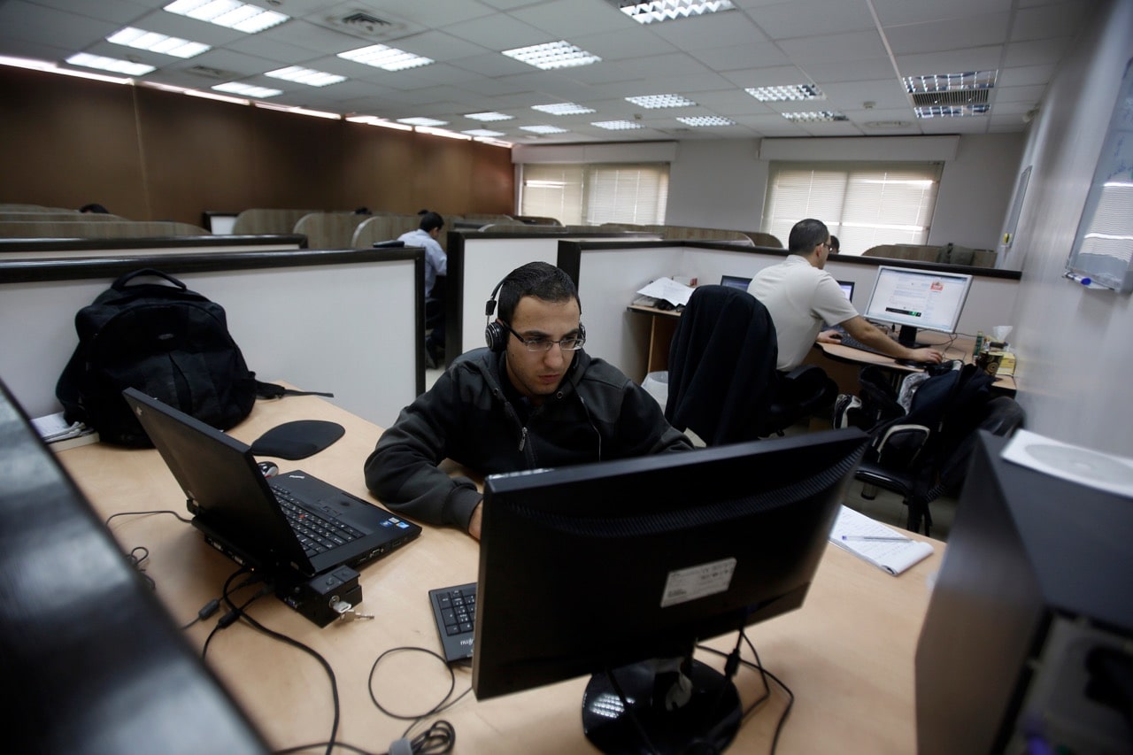 Employees work in the offices of Exalt Technologies in the West Bank city of Ramallah, 7 April 2013, REUTERS/Mohamad Torokman