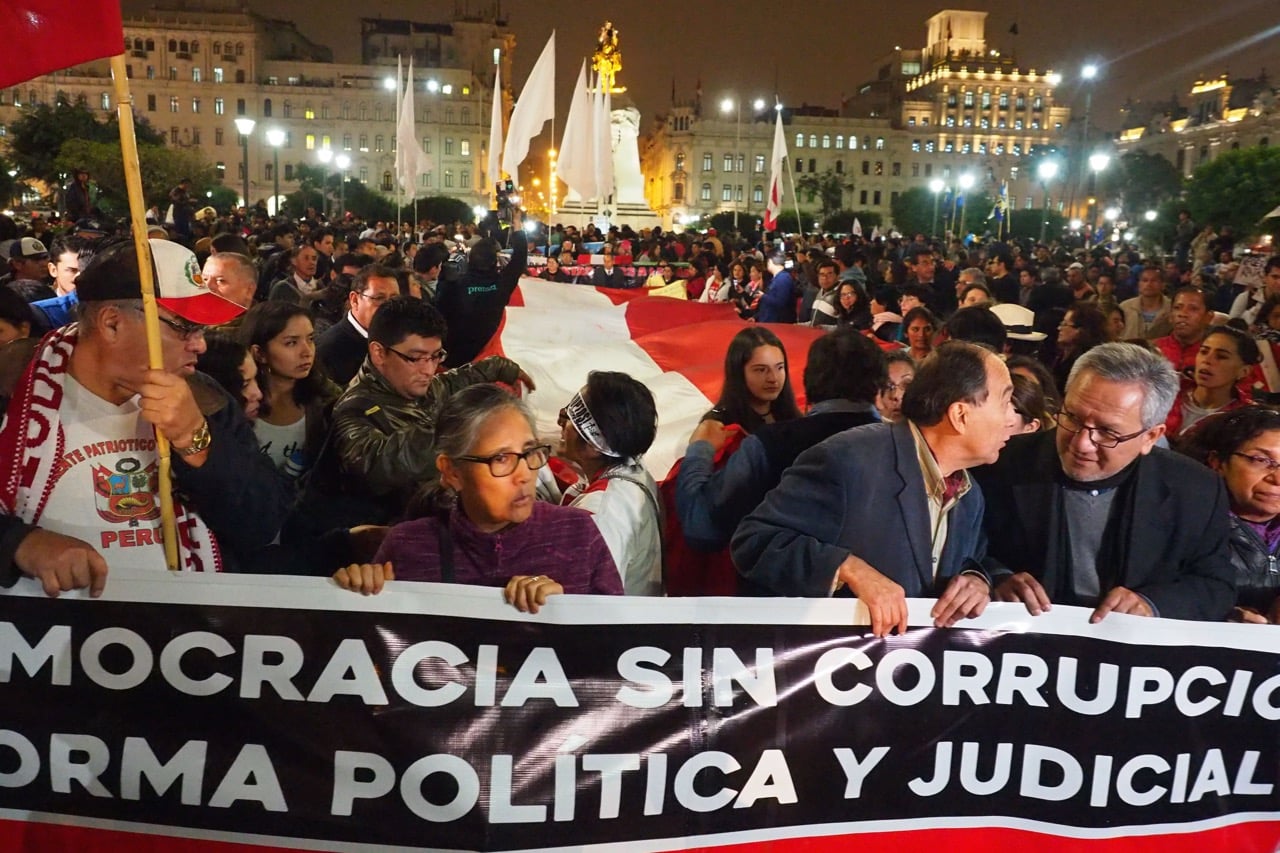 'Democracy without corruption' says a banner during a protest by Peruvians in response to the disclosure of audio recordings revealing corruption, in Lima, 11 July 2018, Carlos Garcia Granthon/Fotoholica Press/LightRocket via Getty Images