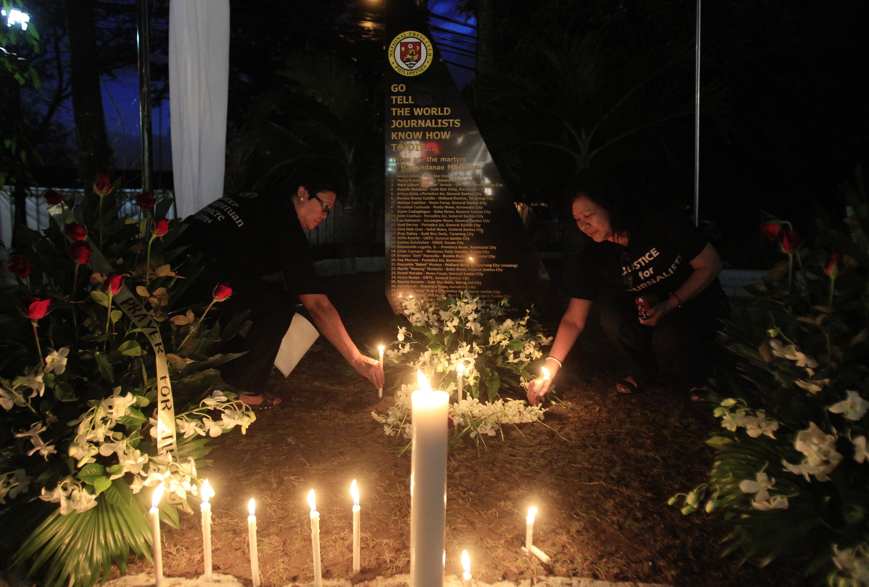 Filipino journalists light candles to commemorate the 2nd year anniversary of the "Maguindanao Massacre" at the National Press Club compound in Manila November 23, 2011. The powerful political Ampatuan clan was accused of masterminding the killing of 57 people, including more than 30 journalists, in Maguindanao, southern Philippines on 23 November 2009, REUTERS/Erik De Castro