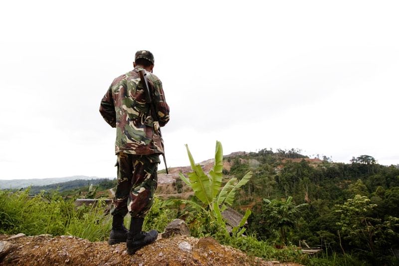 A member of a private security force overlooking Mt. Canatuan, the holy mountain of the Subanen and site of the TVI open pit mine, Alex Felipe