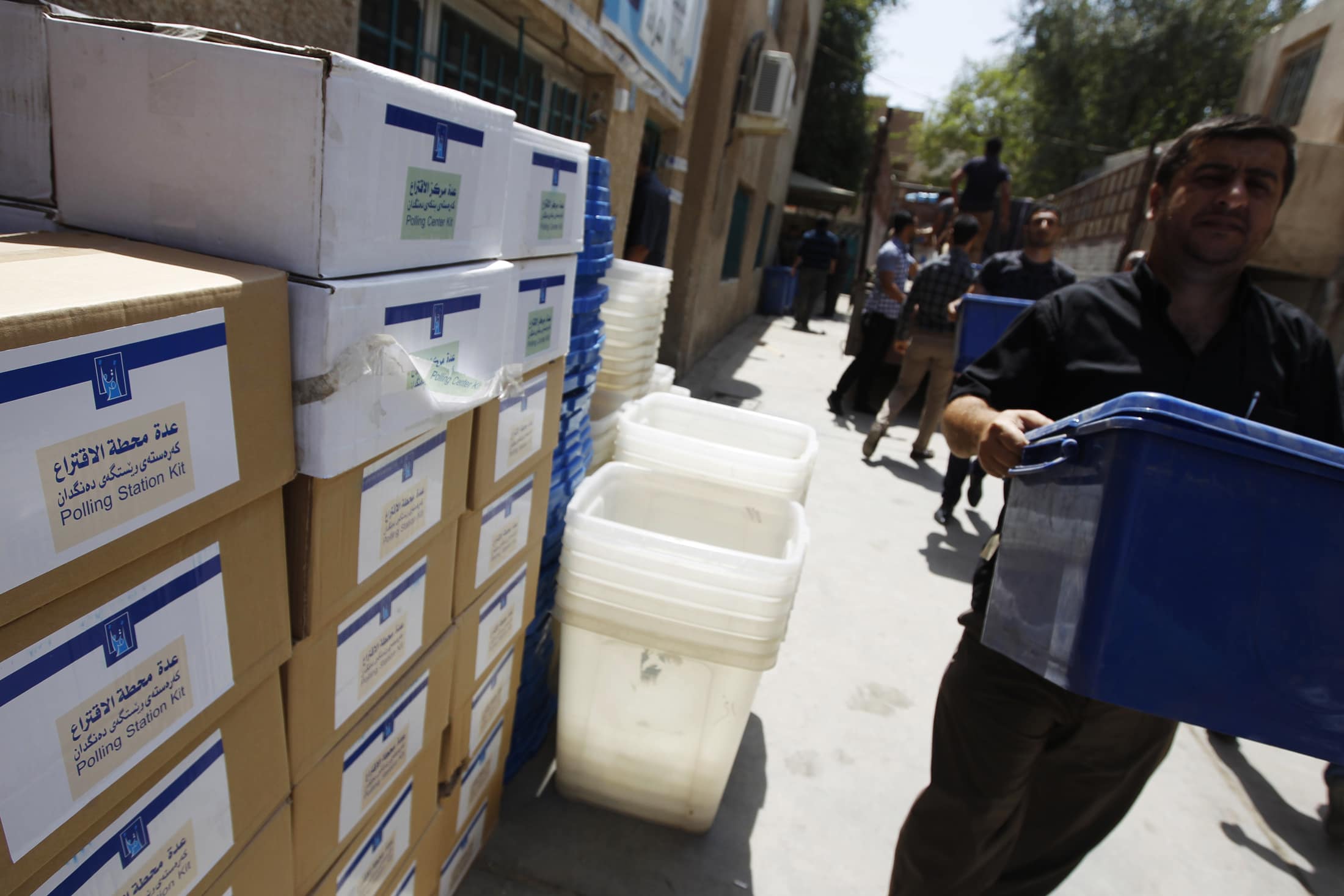 Workers carry ballot boxes as they prepare for the upcoming provincial elections, in Baghdad in 19 April 2013, REUTERS/Thaier al-Sudani