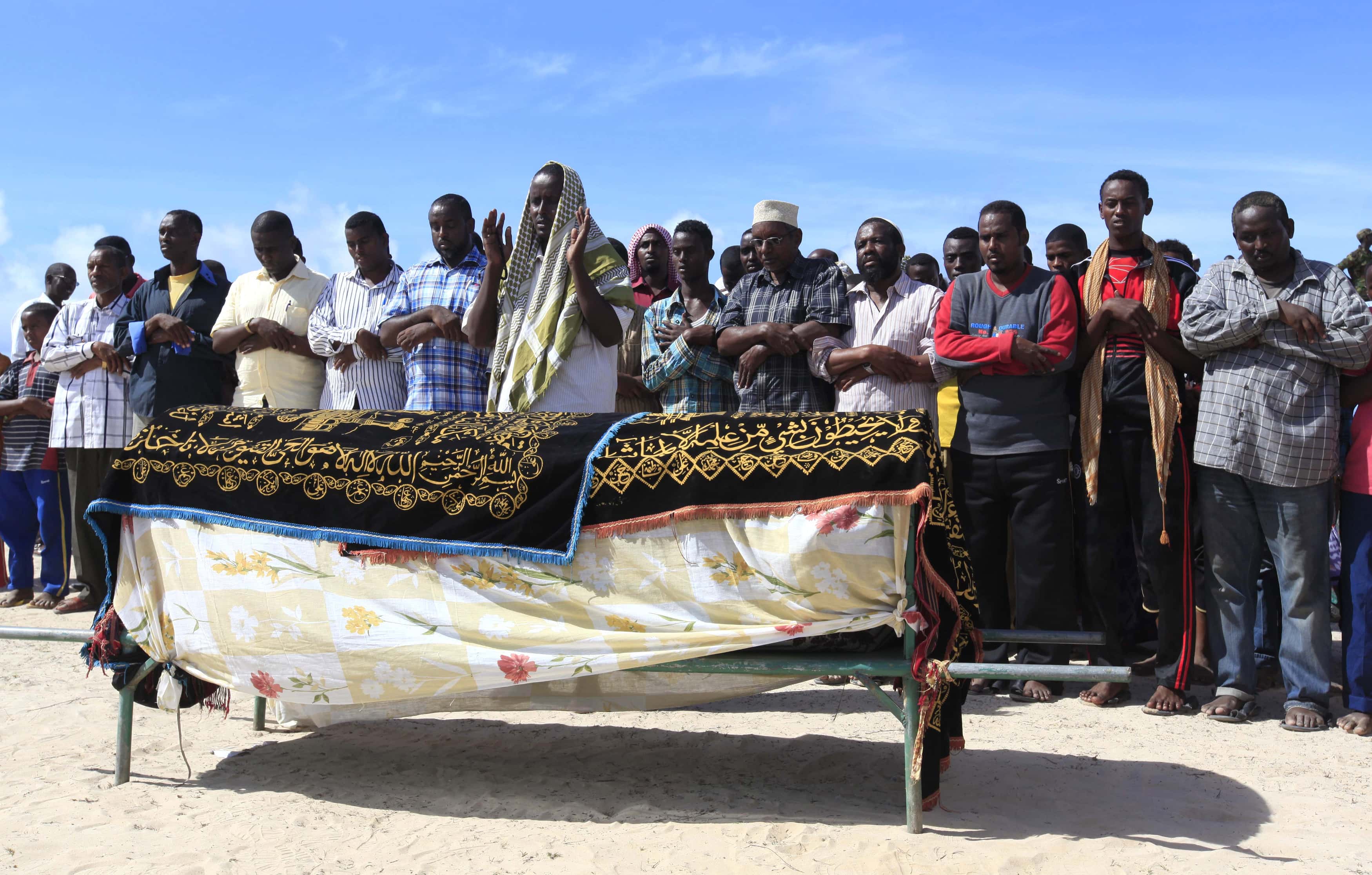 Muslims pray for the slain body of Somali journalist Mohamed Ibrahim Rageh in southern Mogadishu on 22 April 2013, REUTERS/Feisal Omar