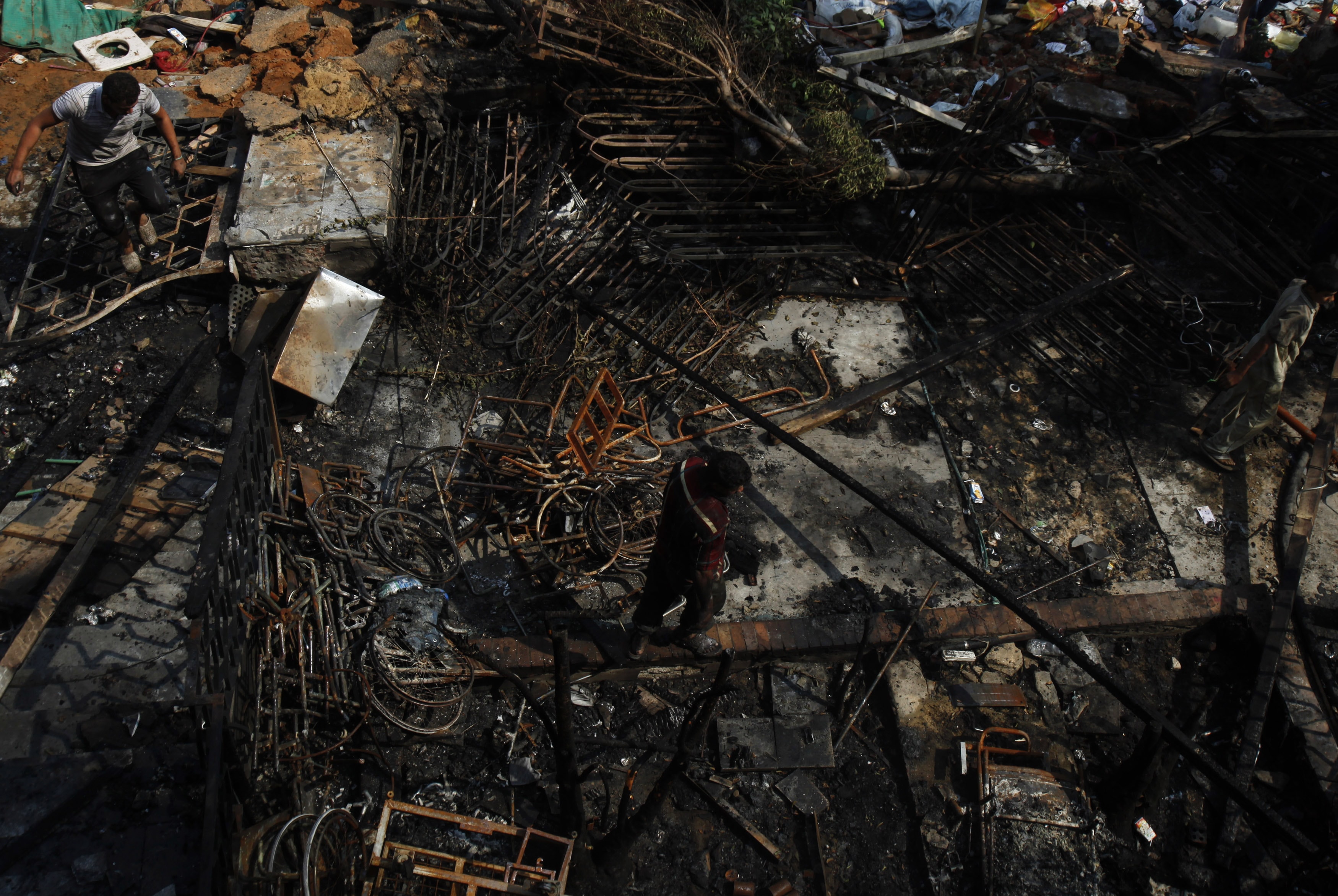 Men move through the Rabaa Adawiya mosque complex the day after the massacre on 15 August 2013, REUTERS/Amr Abdallah Dalsh