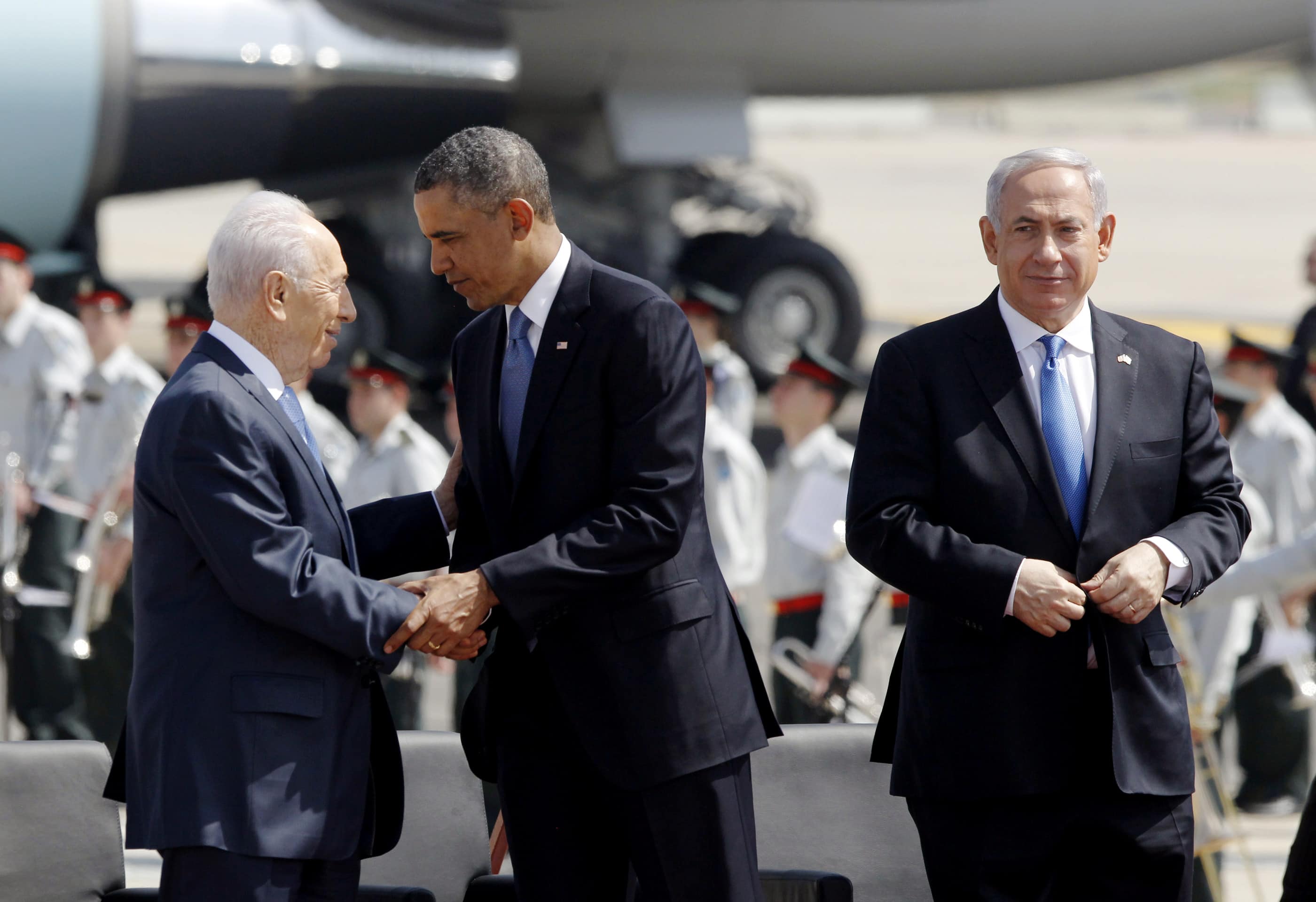 US President Barack Obama shakes hands with Israel's President Shimon Peres alongside Prime Minister Benjamin Netanyahu upon his arrival in Tel Aviv, REUTERS/Jason Reed