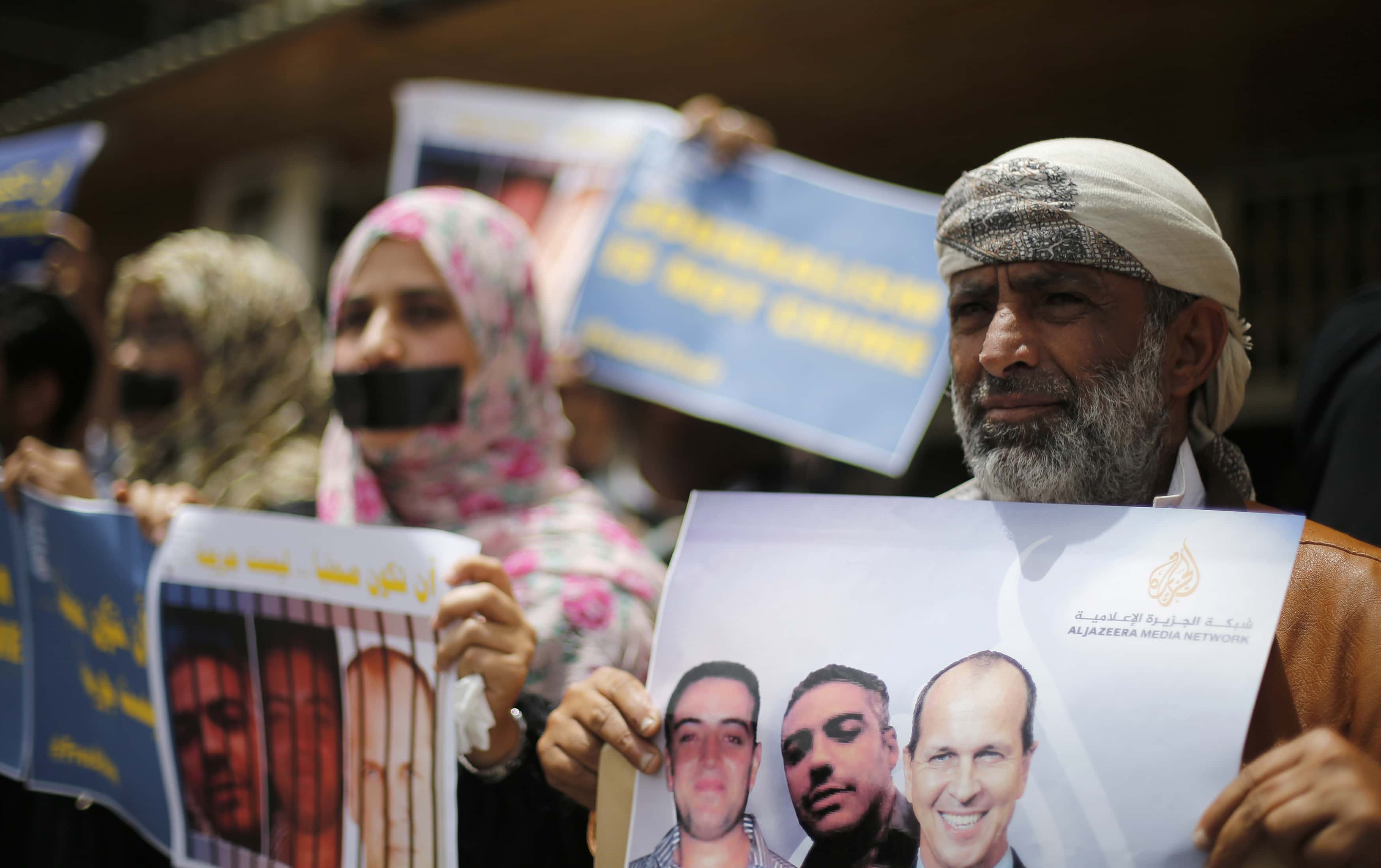 Journalists protest the imprisonment of Al Jazeera journalists Peter Greste, Mohamed Fahmy and Baher Mohamed in Egypt, outside Al Jazeera offices in Sanaa, Yemen on 25 June 2014. , REUTERS/Khaled Abdullah