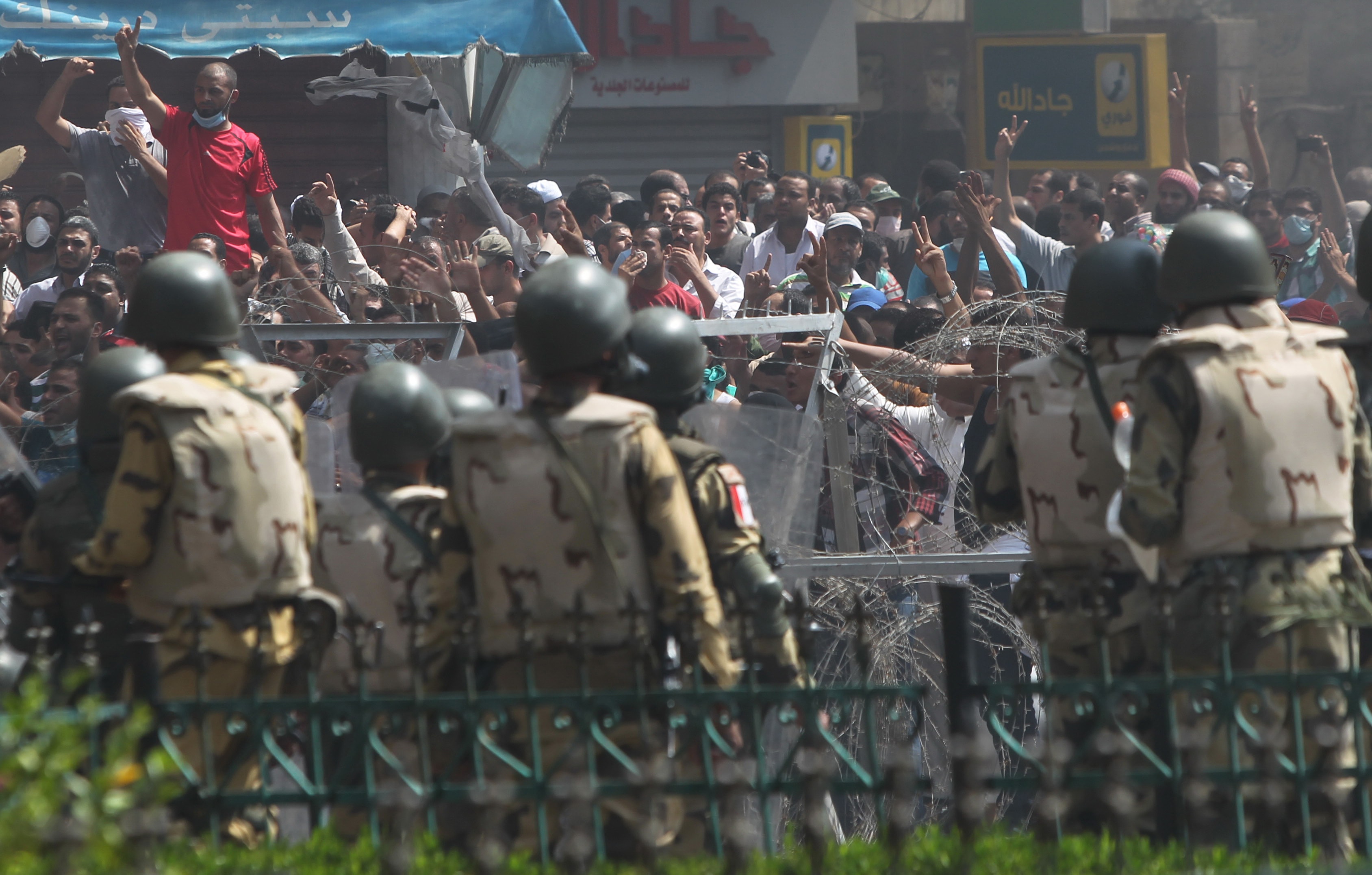 Members of the Muslim Brotherhood and supporters of ousted Egyptian President Mohamed Morsi shout slogans during clashes with riot police and the army in Cairo on 14 August 2013, REUTERS/Asmaa Waguih