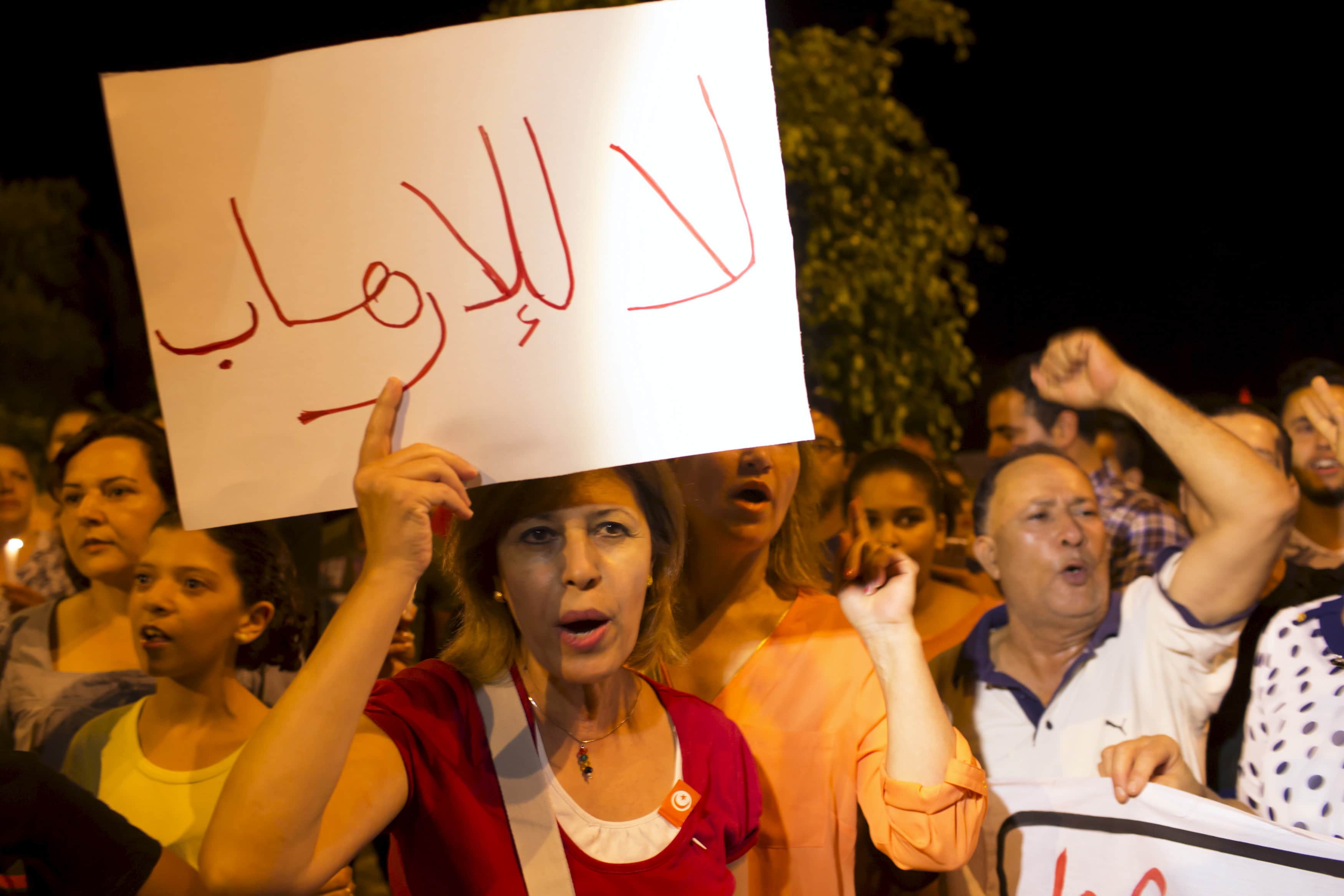 People shout slogans during a protest to condemn an attack by a gunman at the beach of the Imperial Marhabada hotel in Sousse, Tunisia, June 27, 2015., REUTERS/Zohra Bensemra