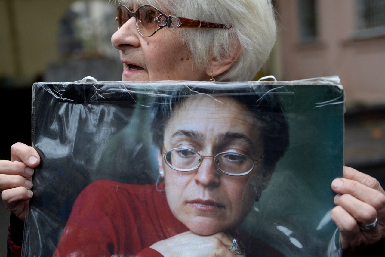 A woman holds a portrait of slain Russian journalist Anna Politkovskaya during a rally marking the 10th anniversary of her murder in Moscow, 7 October 2016, NATALIA KOLESNIKOVA/AFP/Getty Images