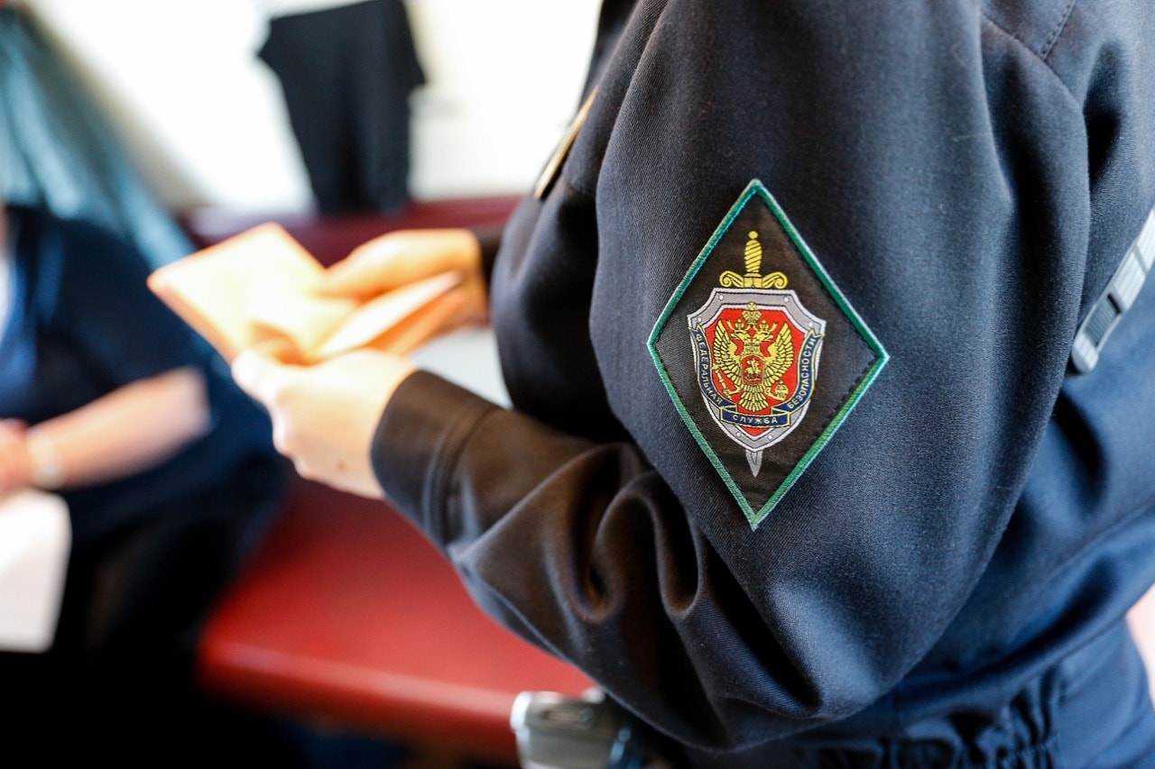 An FSB officer performs an ID check on a passenger train near the Russian-Lithuanian border, in Kaliningrad region, Russia, 2 October 2017, Vitaly NevarTASS via Getty Images