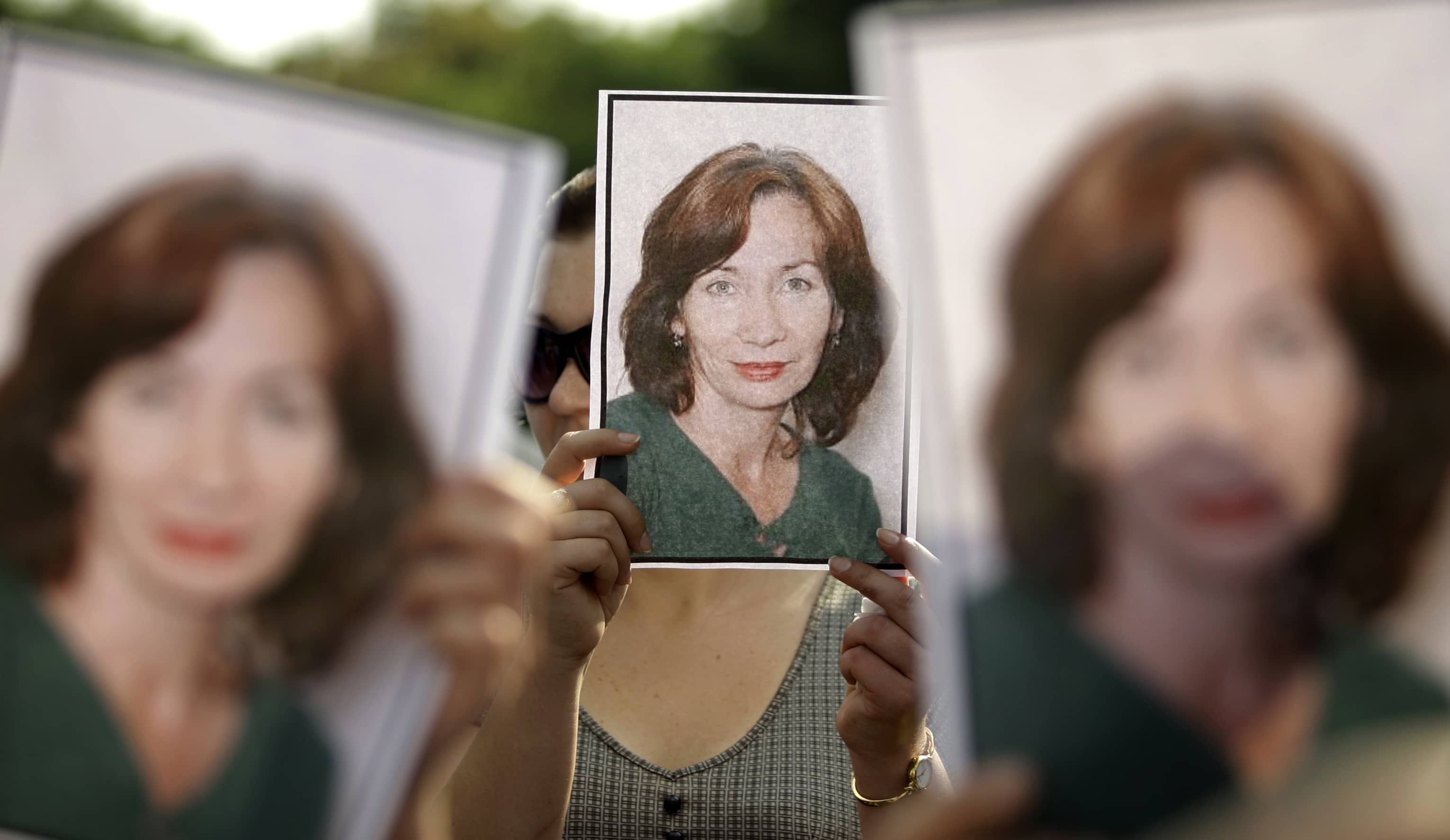 People hold portraits of murdered rights activist Natalya Estemirova during a rally in Moscow, 16 July, 2009., Associated Press/Sergey Ponomarev