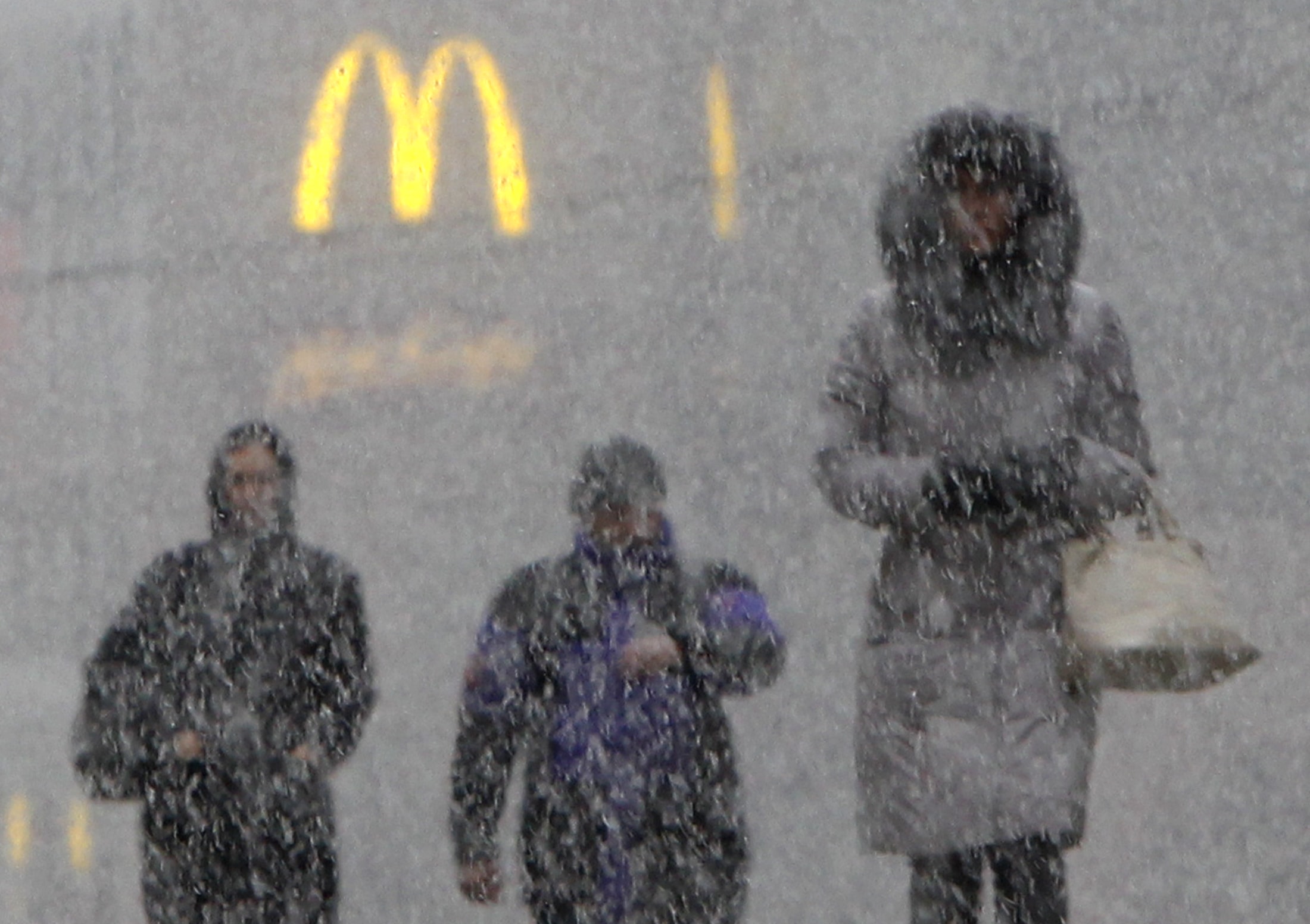 People walk under heavy snow in central Moscow, November 2011., REUTERS/Anton Golubev