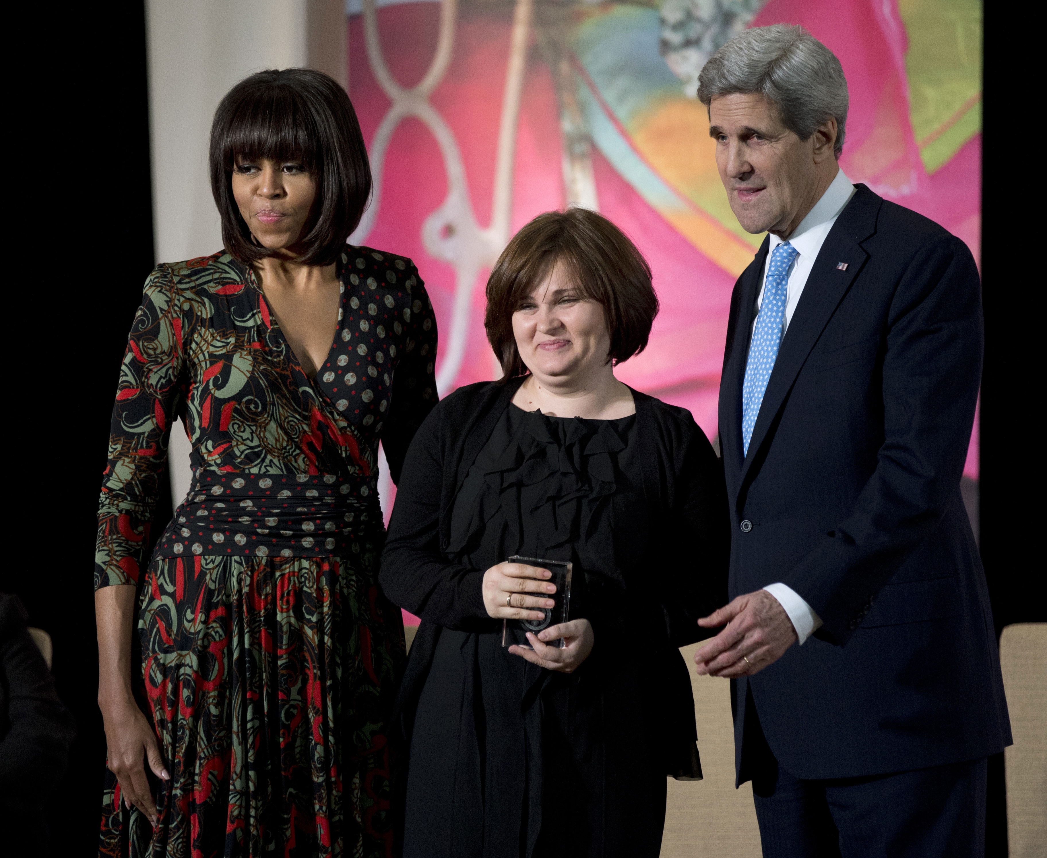 First lady Michelle Obama, left, and Secretary of State John Kerry, right, honor Russian human rights activist, journalist Elena Milashina, with a Secretary of State’s International Women of Courage Award during a ceremony at the State Department in Washington, 8 March 2013, AP Photo/Manuel Balce Ceneta