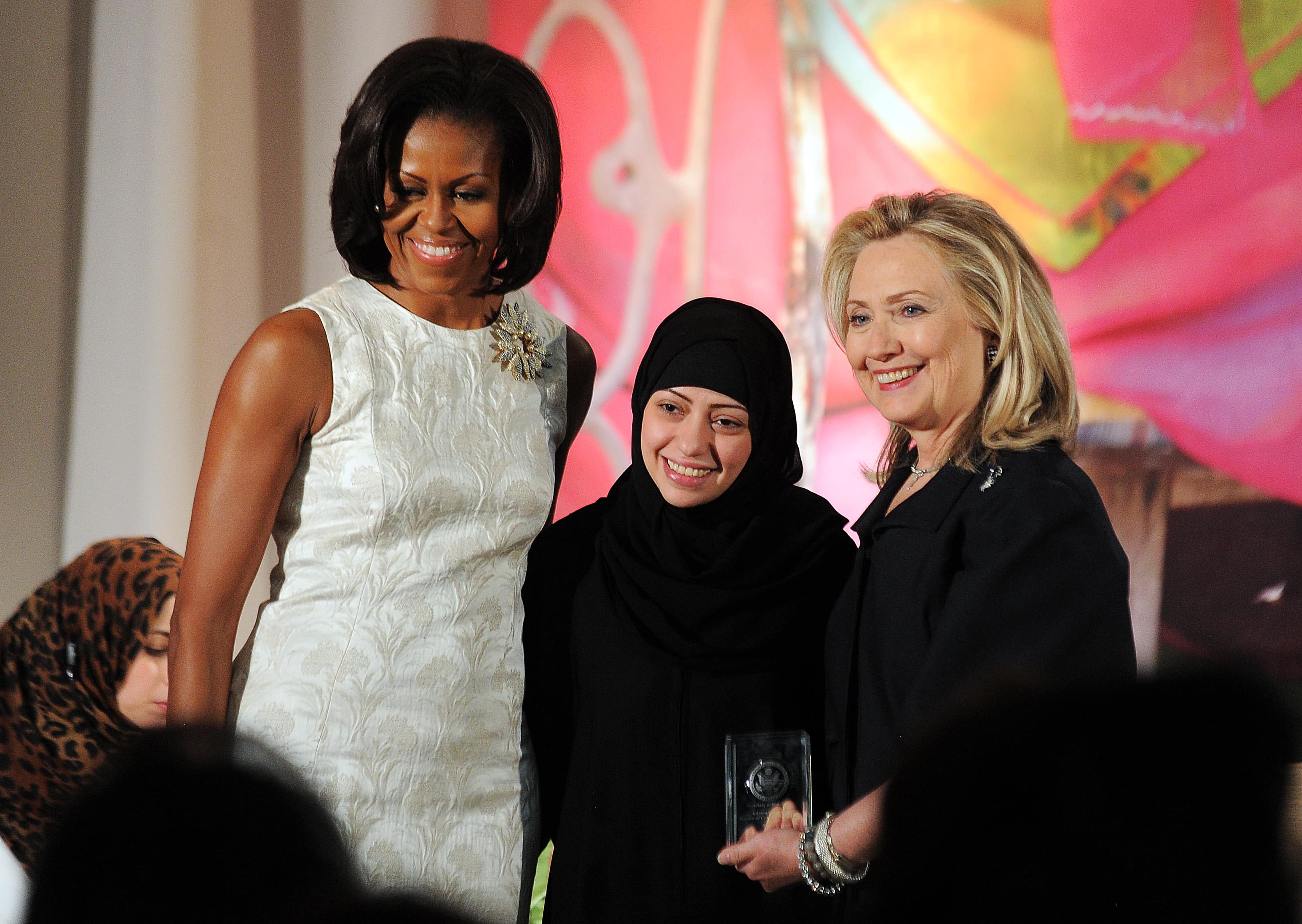 Samar Badawi receives the International Women of Courage Award from US First Lady Michelle Obama and Secretary of State Hillary Clinton, Washington DC, United States, 8 March 2012, JEWEL SAMAD/AFP/Getty Images