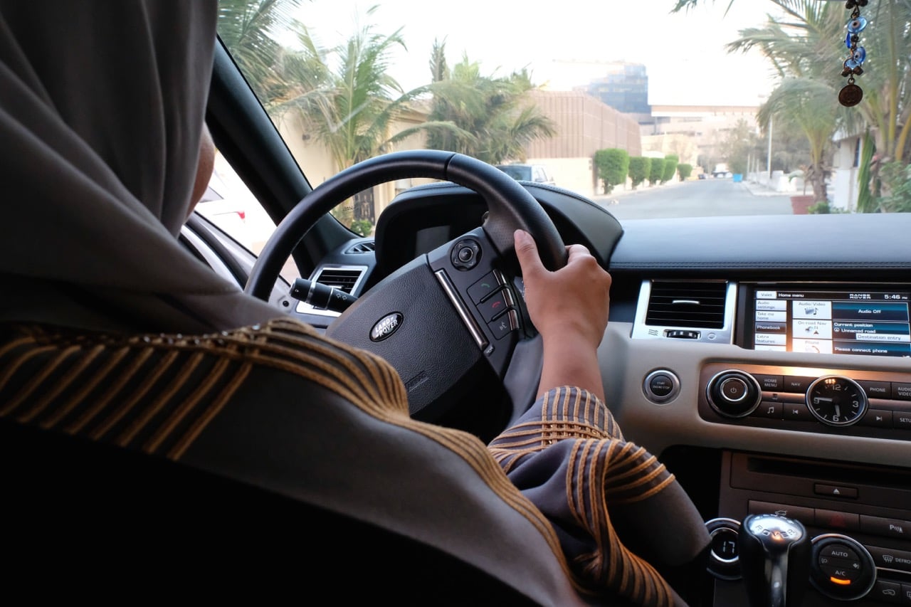 A Saudi woman drives her car along a street in the coastal city of Jeddah, 27 September 2017, REEM BAESHEN/AFP/Getty Images