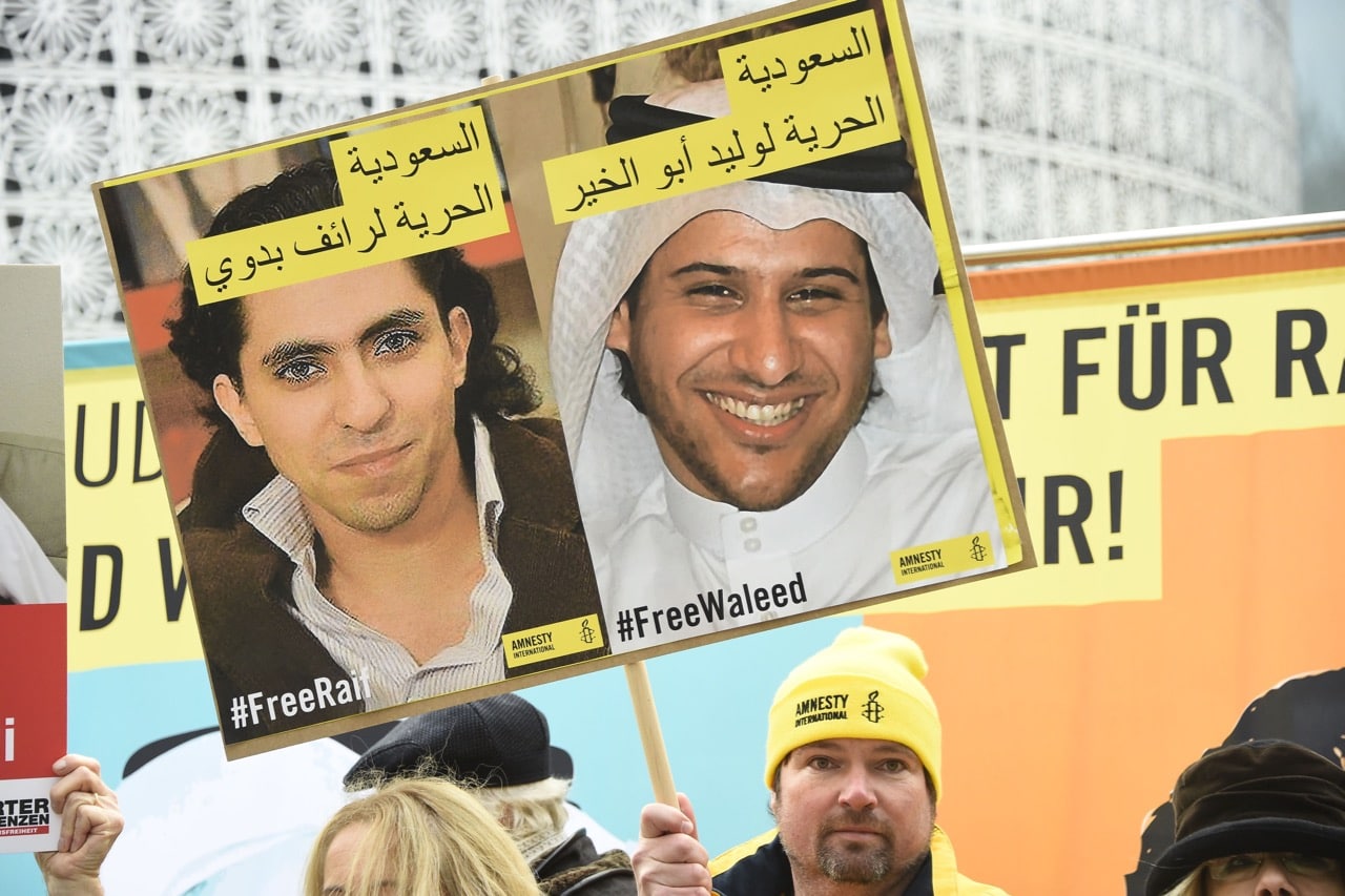 Members of human rights NGO Amnesty International hold up portraits of jailed Saudi blogger Raif Badawi and human rights activist and lawyer Waleed Abu Alkhair as they demonstrate in front of the embassy of Saudi Arabia in Berlin, 8 January 2016, TOBIAS SCHWARZ/AFP/Getty Images