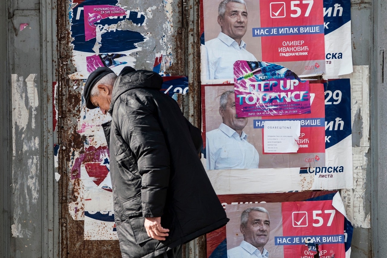 A Kosovo Serb man walks past posters featuring Serb politician Oliver Ivanovic, in the northern part of the divided town of Mitrovica, Kosovo, 1 February 2018; journalist Stefan Cvetkovic had reported on the murder of Ivanonic, ARMEND NIMANI/AFP/Getty Images