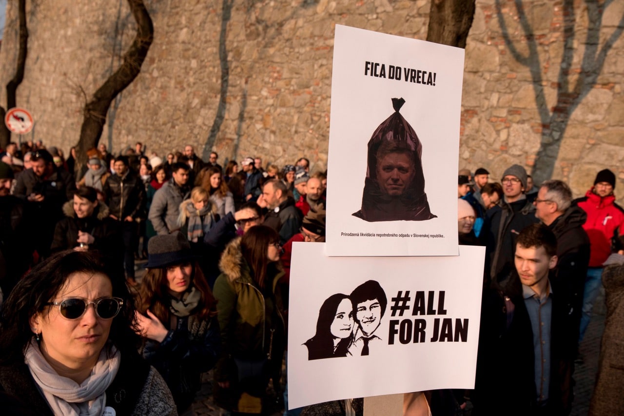 A placard with a picture of outgoing Prime Minister Robert Fico is seen over a placard of murdered journalist Jan Kuciak and his fiancee during a protest in Bratislava, 26 March 2018  Protesta en Bratislava, Eslovaquia, el 26 de marzo de 2018  Une manifestation a Bratislava, Slovakie, le 26 mars 2018, JOE KLAMAR/AFP/Getty Images