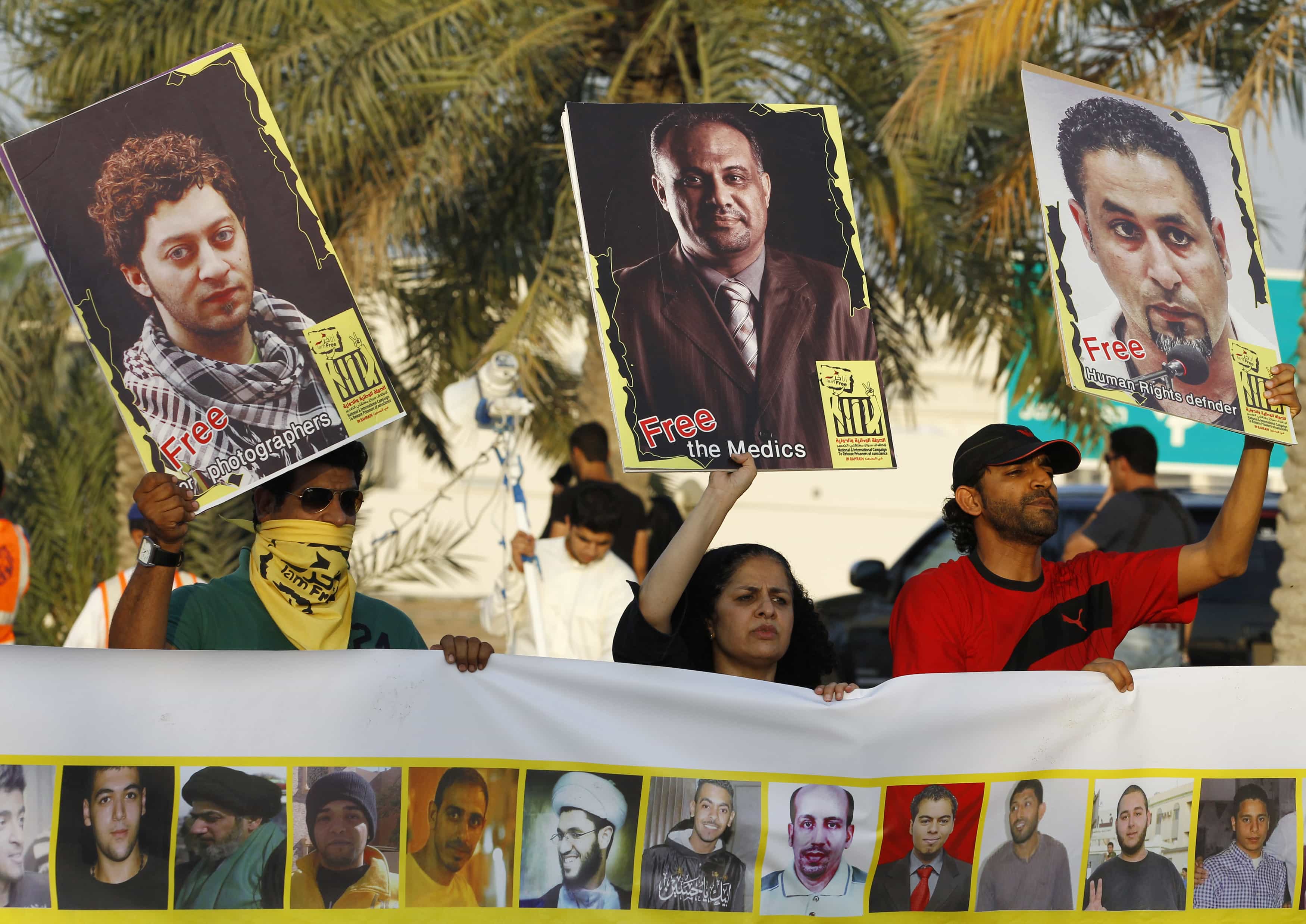 Protesters hold up pictures of journalists, doctors, and activists as they take part in a solidarity march asking for their release in Manama on 9 May 2014, REUTERS/Hamad I Mohammed