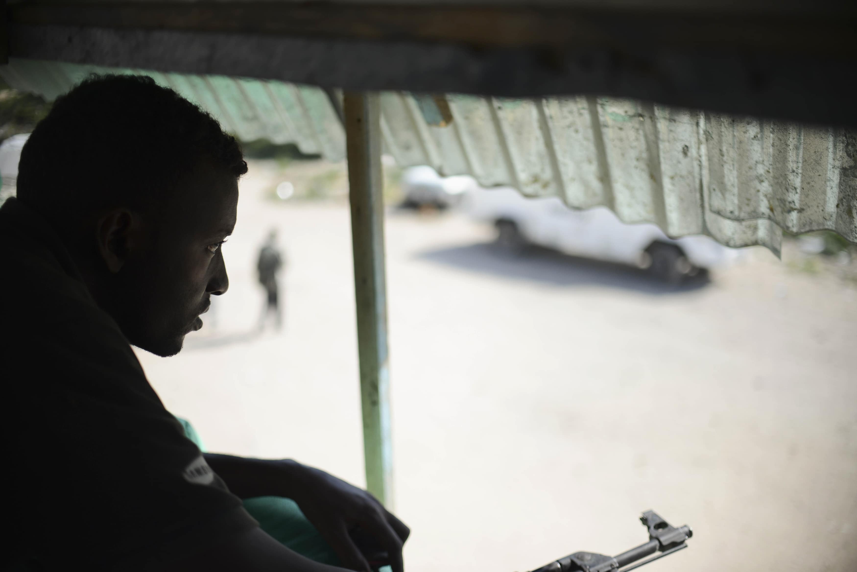 An armed security guard stands watch on a tower constructed within the compound of Radio Shabelle in Mogadishu, 8 December 2012., REUTERS/AU-UN IST Photo/Tobin Jones/Handout