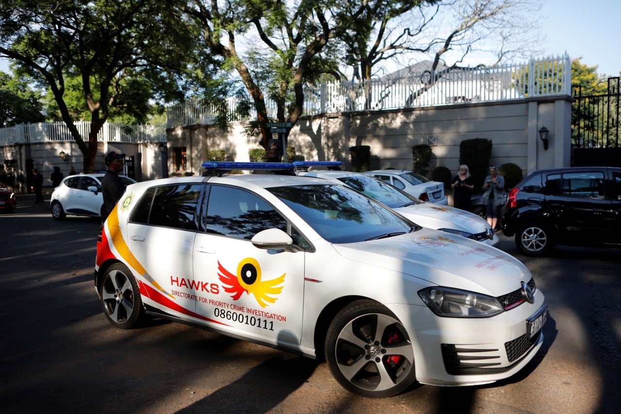 A patrol car belonging to the Hawks, The Directorate for Priority Crime Investigation, is seen outside the compound of a controversial business family in Johannesburg, South Africa, 14 February 2018, WIKUS DE WET/AFP/Getty Images
